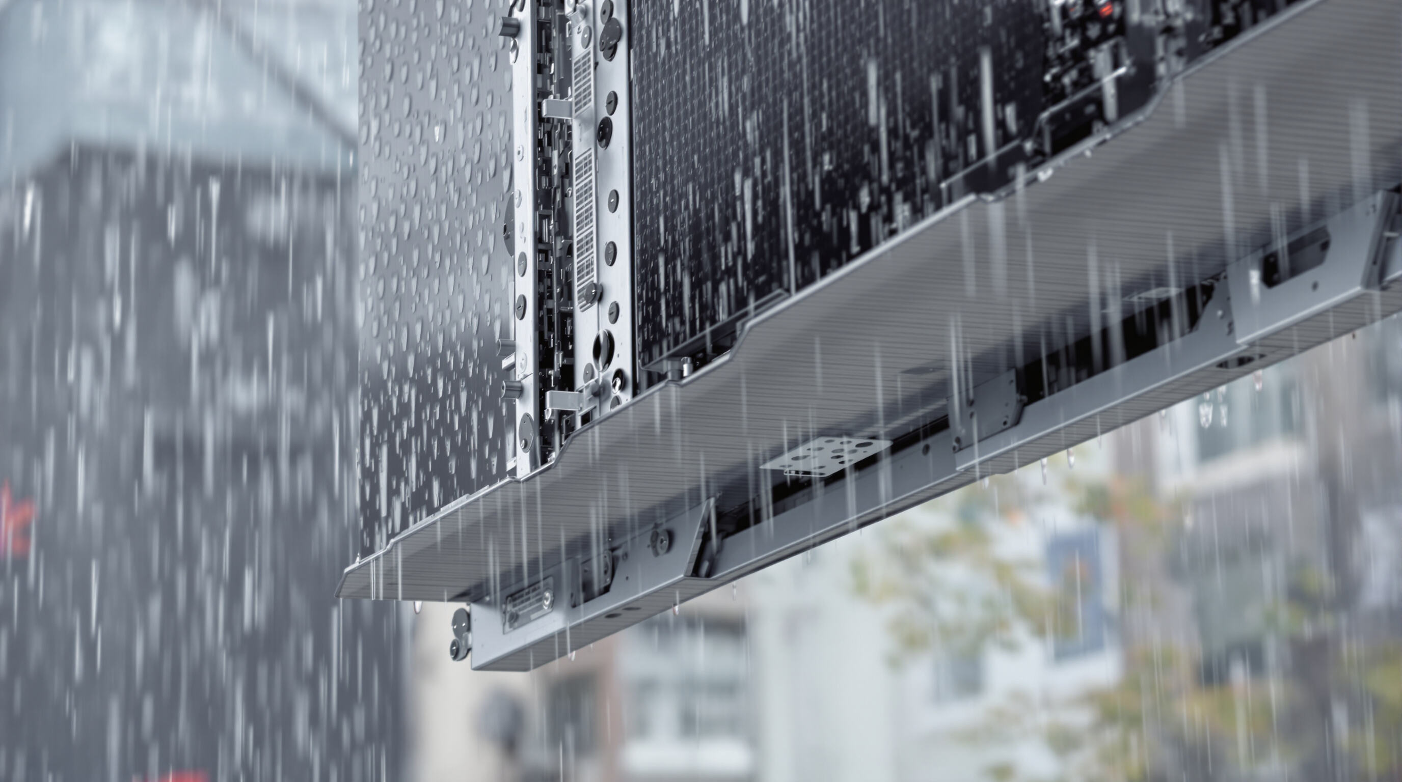 Close-up of waterproof LED display panel outdoors during rain with sealed frame and visible water protection details
