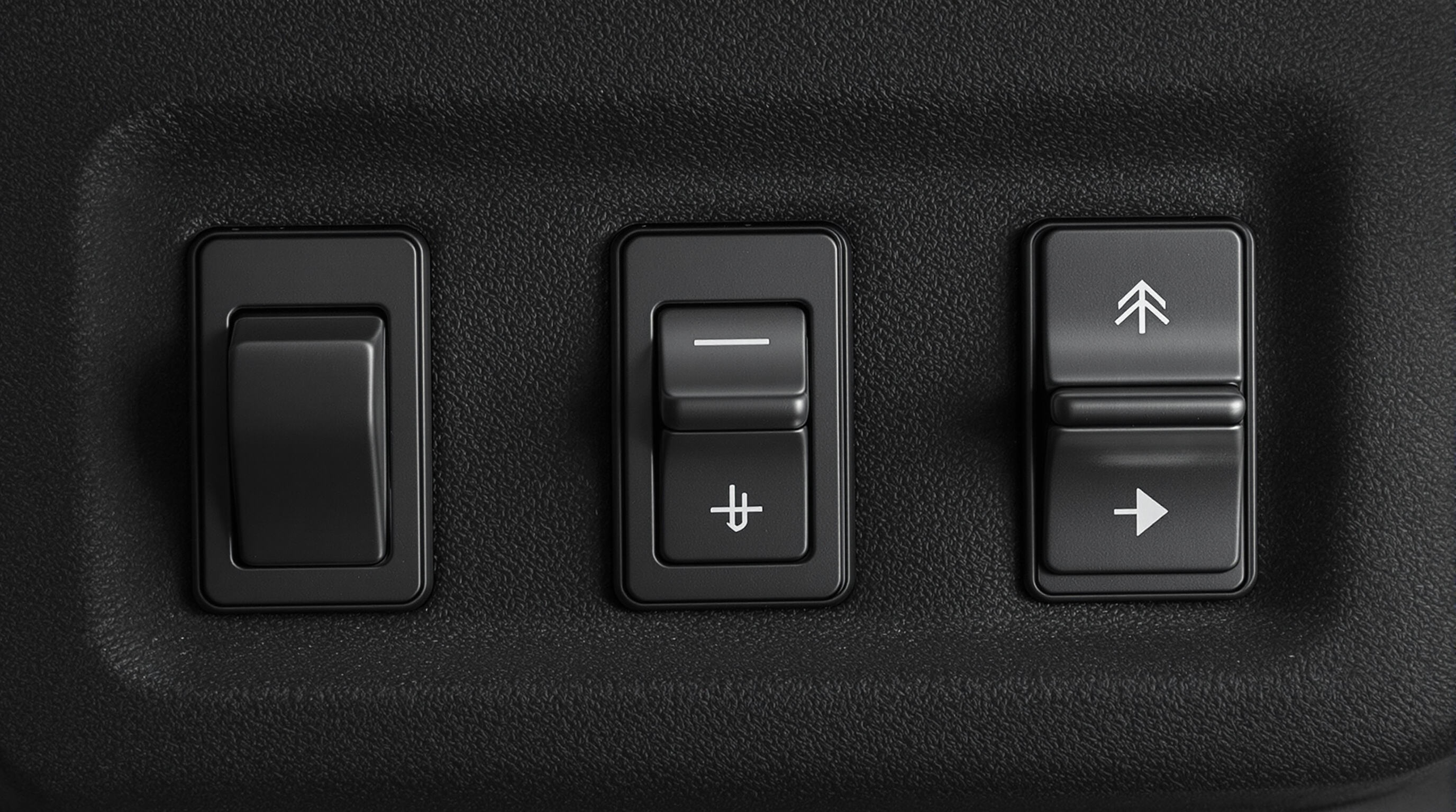 Realistic photo showing rocker, toggle, and capacitive switches side by side on a dark background