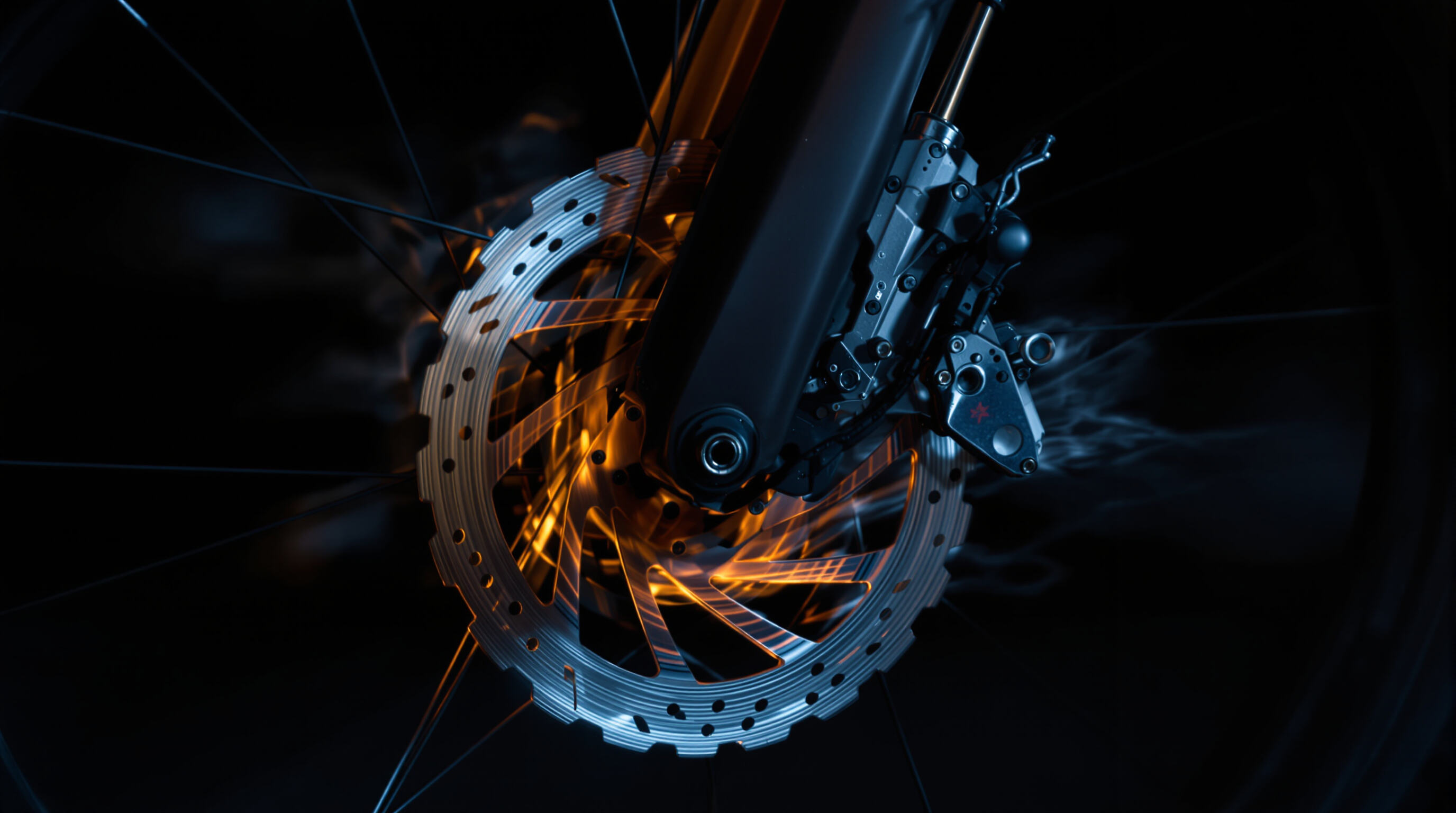 E-bike disc brake rotor glowing with heat and steam during intense downhill braking