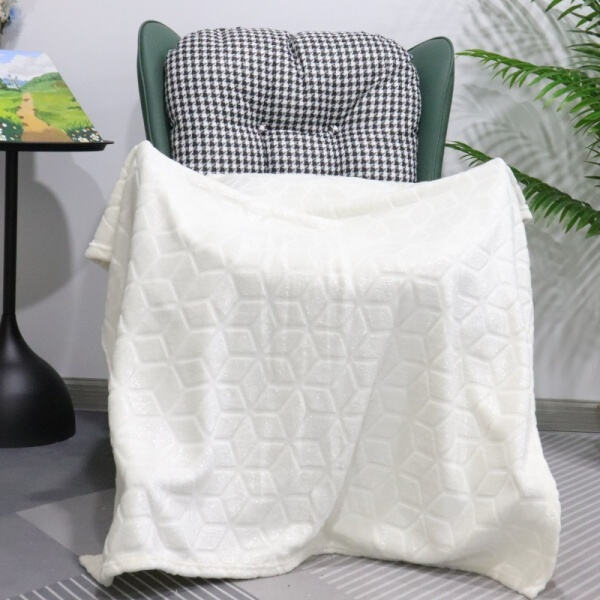 Wrap yourself in warmth with a fuzzy white plush blanke