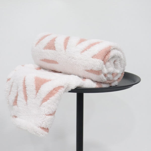 Make your bed the ultimate cozy haven with a fleece and sherpa blanket.