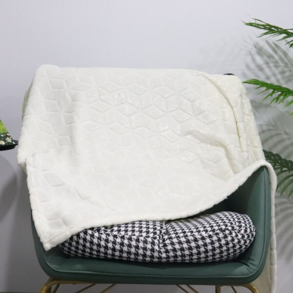 Elevate your bedding with a stylish white plush blanke