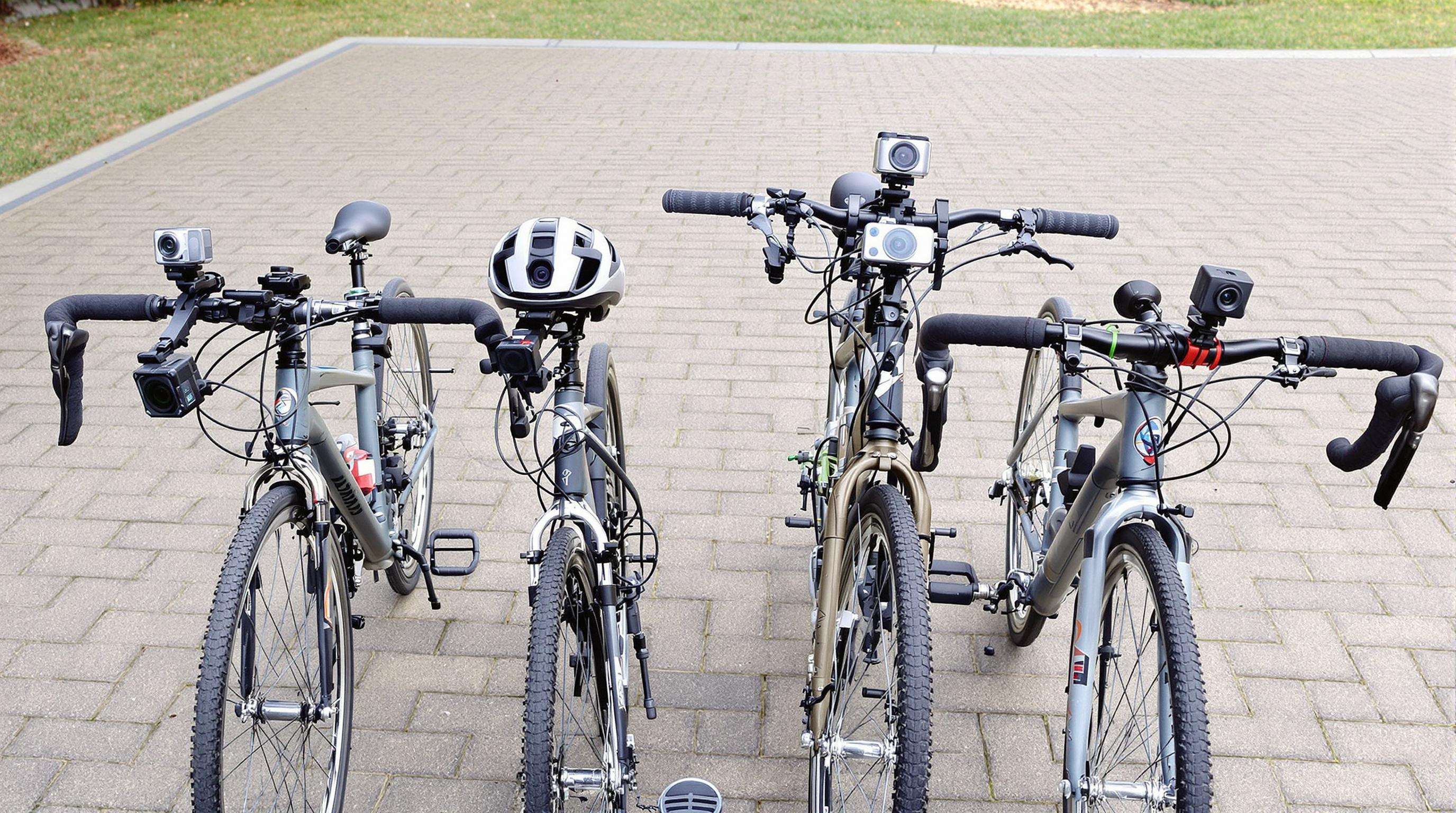 Four bicycles lined up, each displaying a different camera mount position for 360-degree cycling footage.