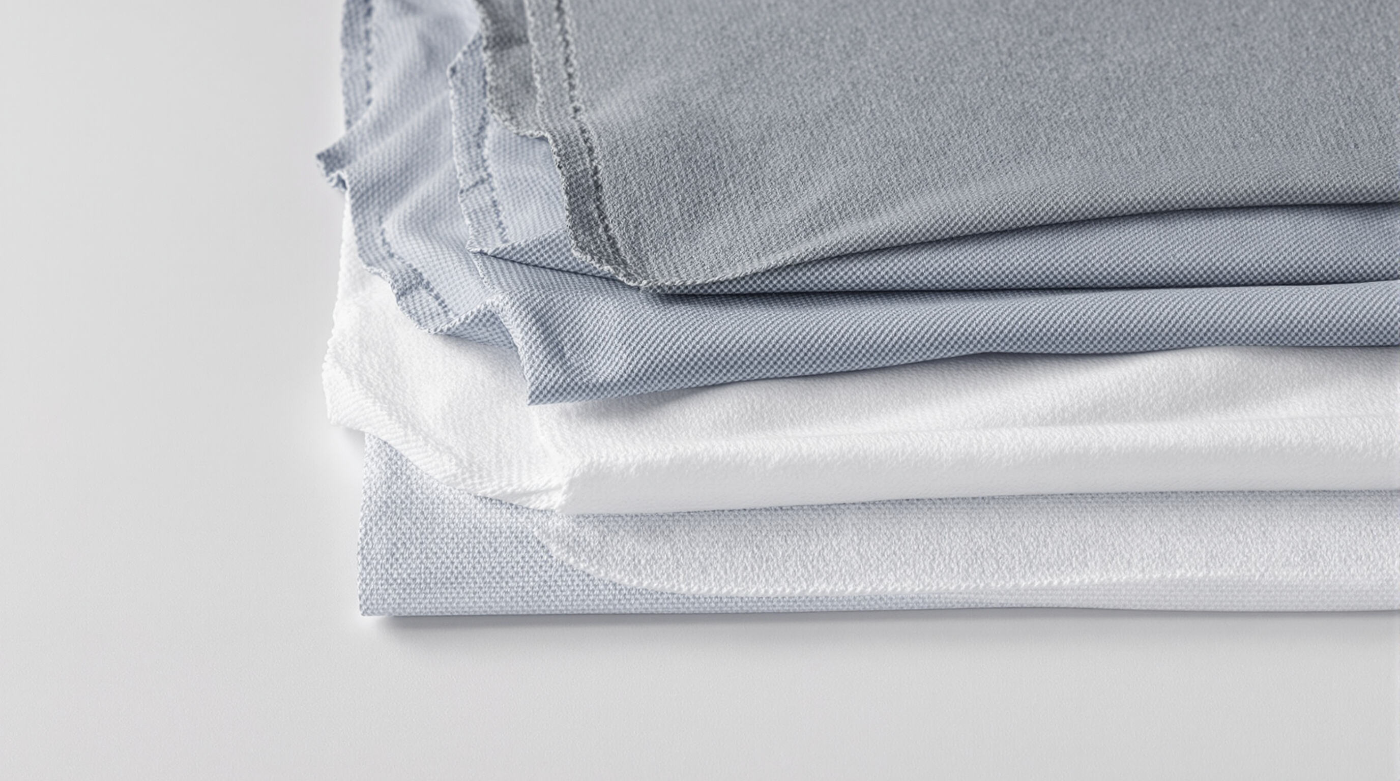 Photograph showing separated pad layers including topsheet, absorbent core, and backsheet for component clarity