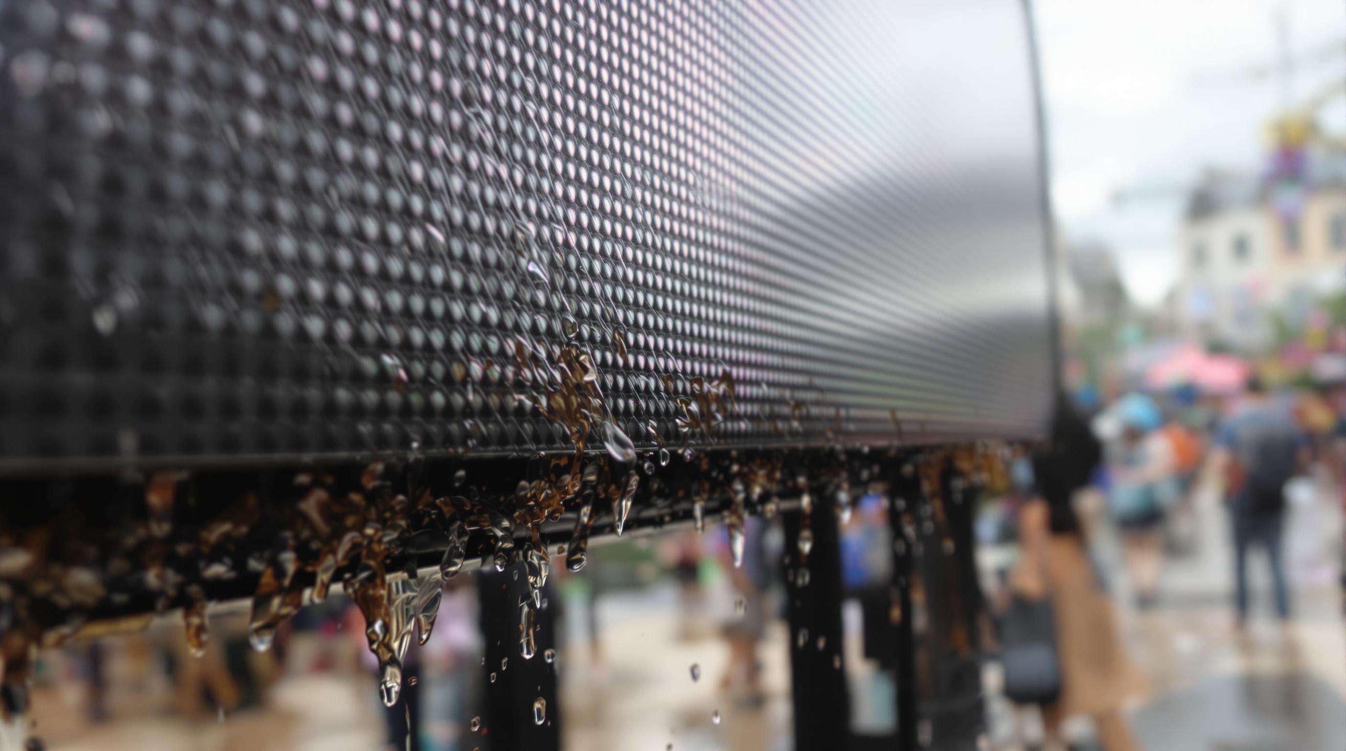 Close-up of an outdoor LED screen shedding rainwater and resisting dust at an event
