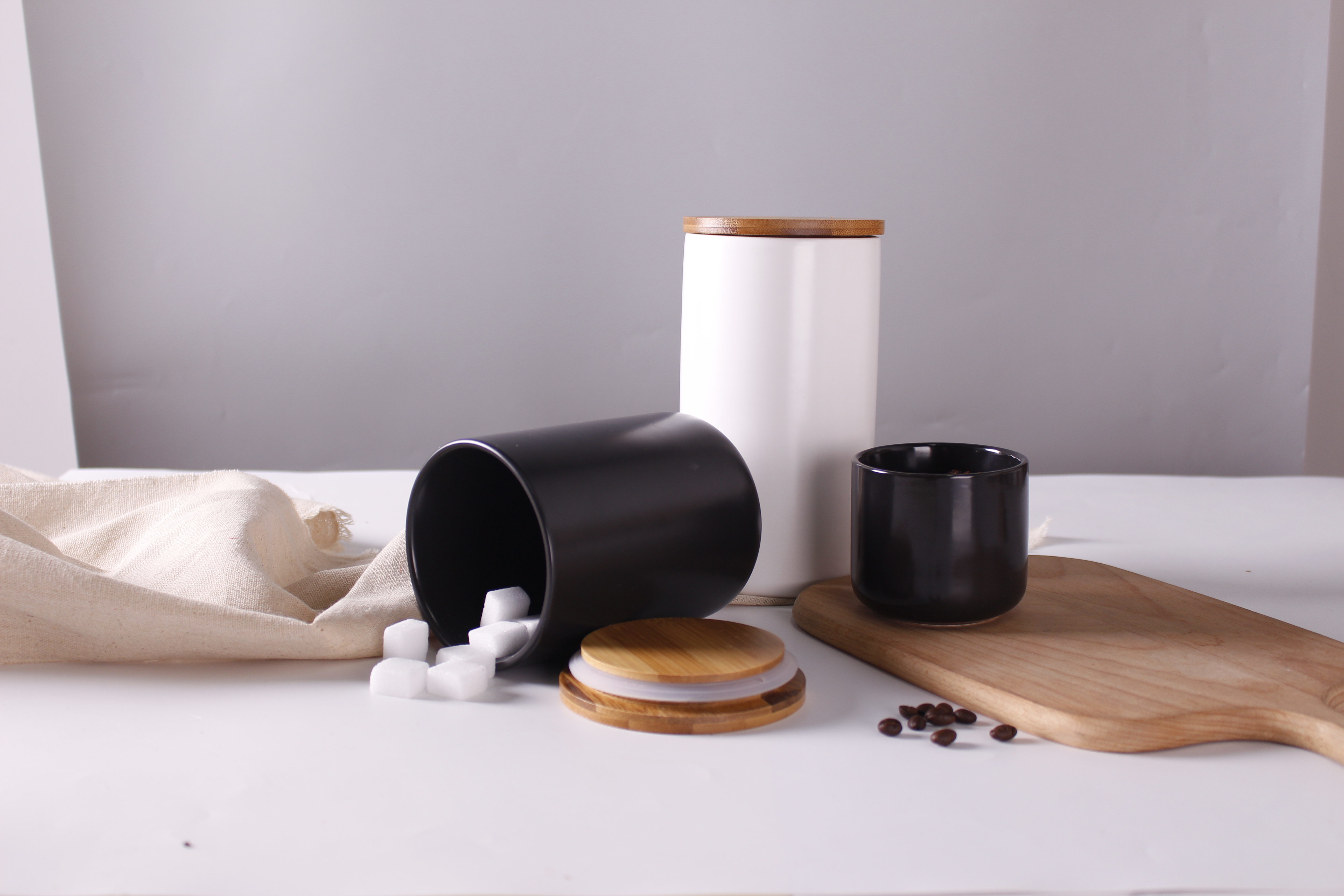 Practical customizable white black kitchenware ceramic storage jar with a wooden lid for home uses supplier