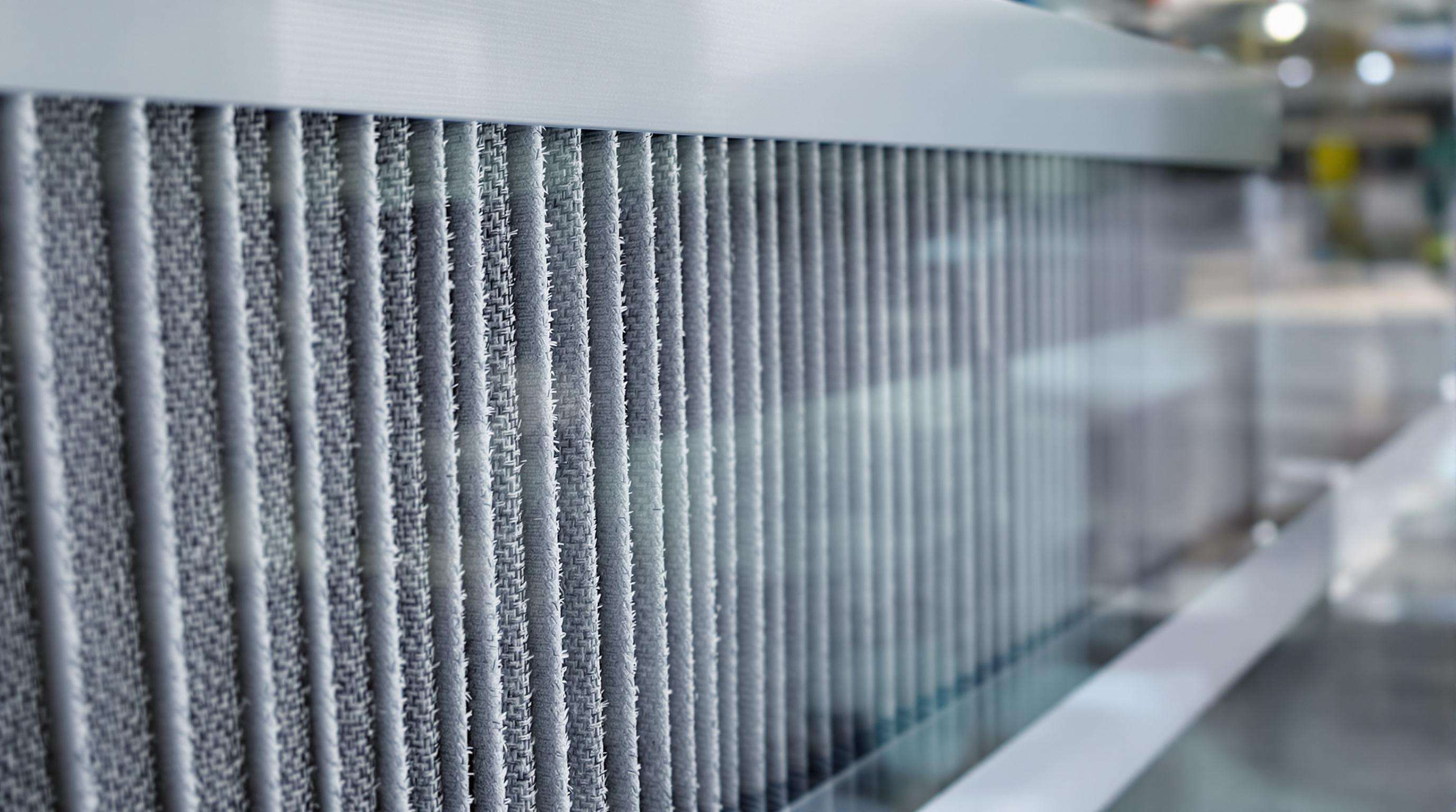 Eco-friendly pleated filter made from biodegradable material inside a modern factory, emphasizing sustainability