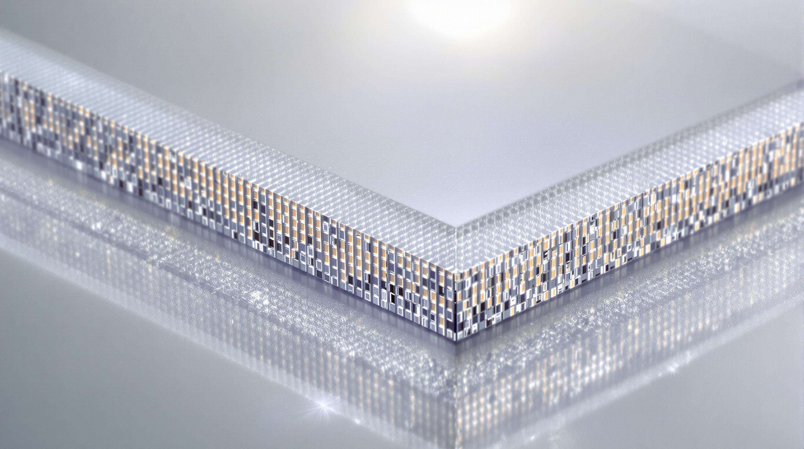 Close-up view of a transparent LED display panel revealing micro-pixel arrays and nanomaterial layers with light shining through