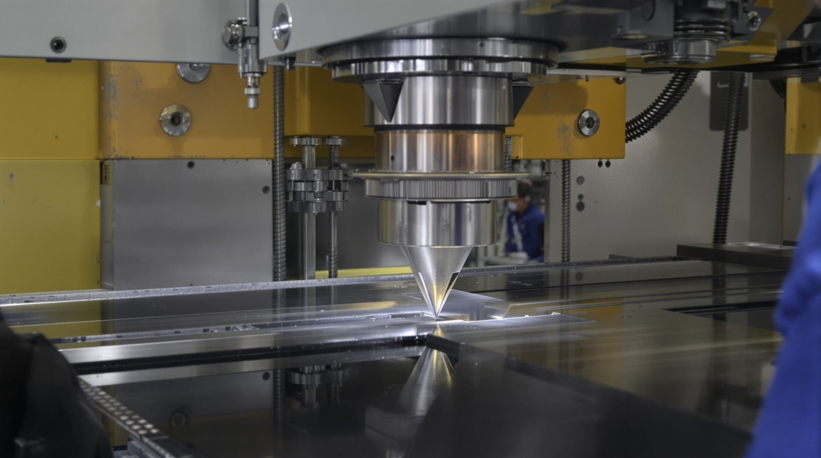 Photorealistic close-up of a press brake bending a metal sheet with operator hands and industrial background