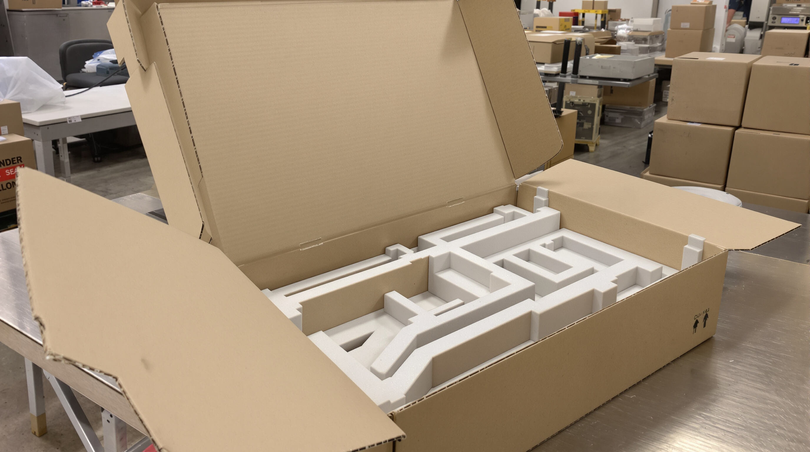 Open gift box with reinforced corners and die-cut internal trays designed for protective packing.