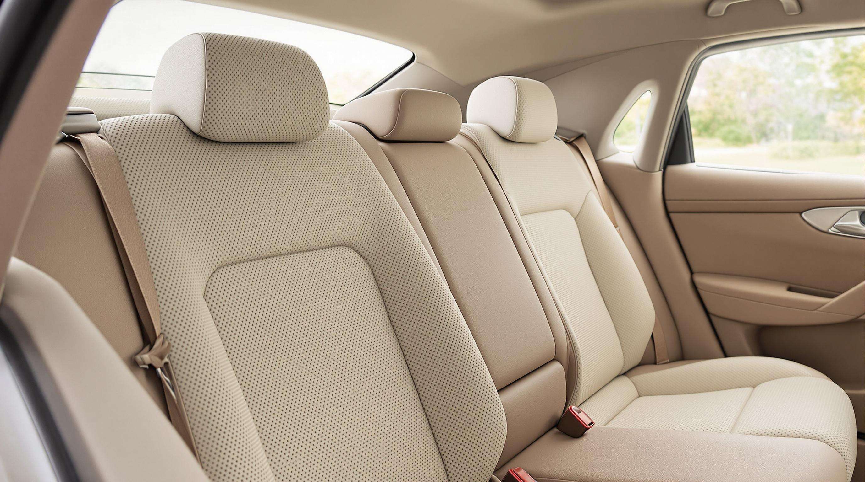 Close-up of a car interior with sustainable materials like coconut fiber and mushroom leather on seats and panels.