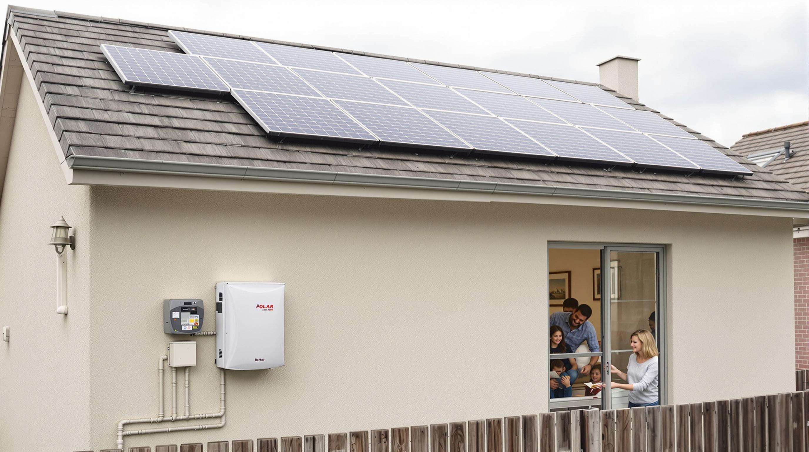 Photograph of solar panels on a home rooftop with a nearby battery storage unit illustrating residential solar and battery integration.