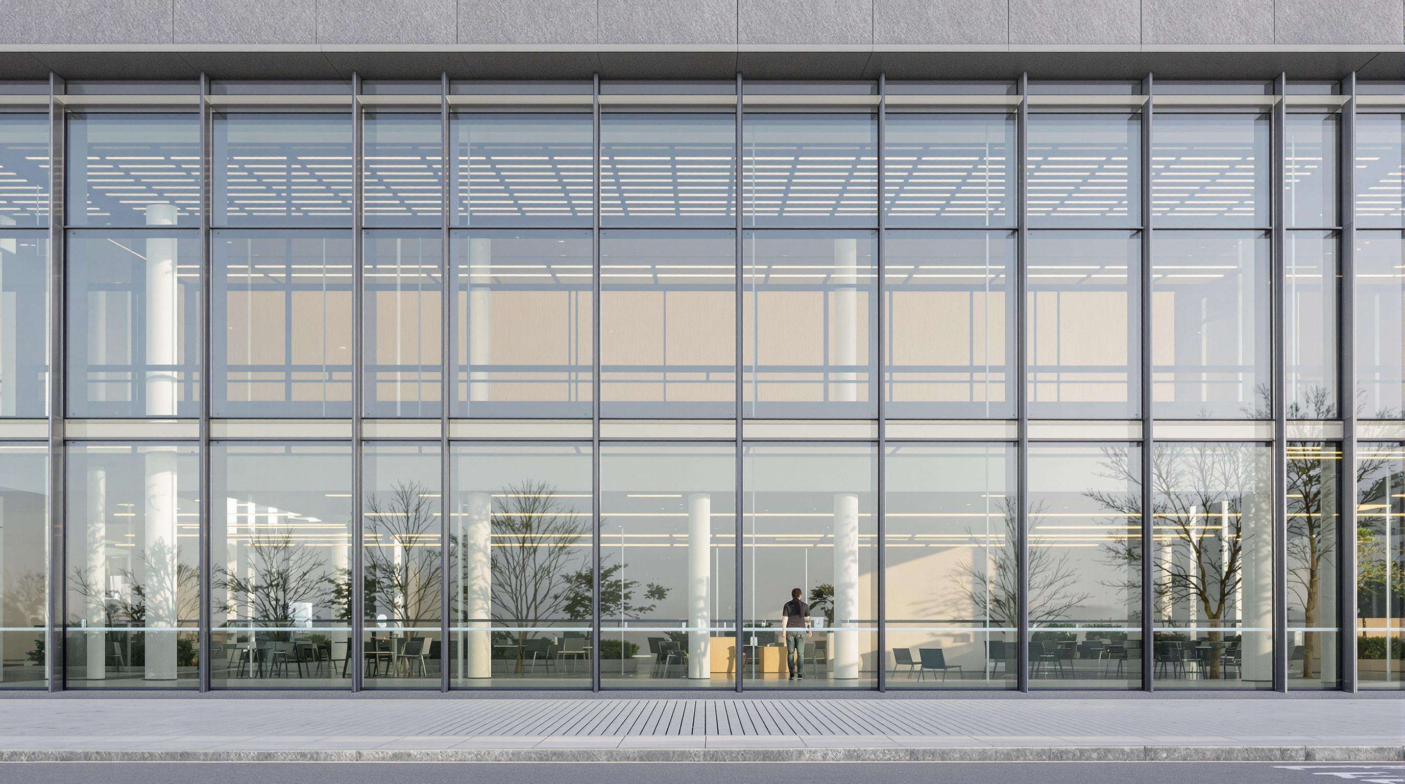 Office building exterior with double skin glass facade and photovoltaic panels, showing air gap and facade details