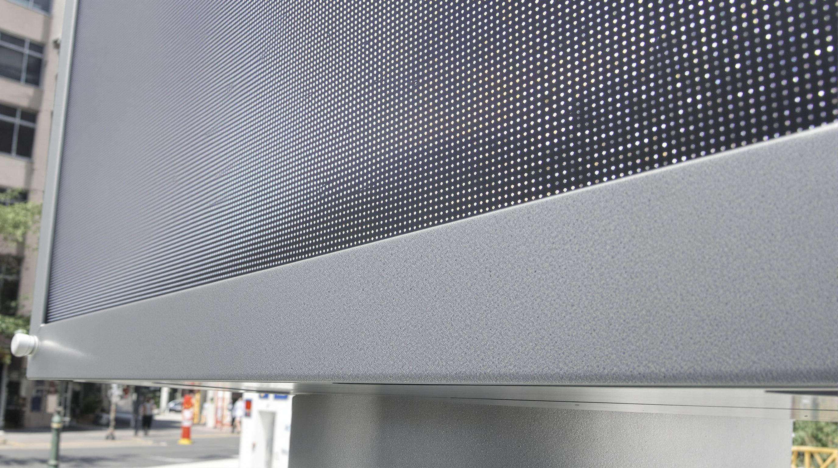 Outdoor LED billboard featuring light sensor, anti-reflective coating, and heat dissipation elements