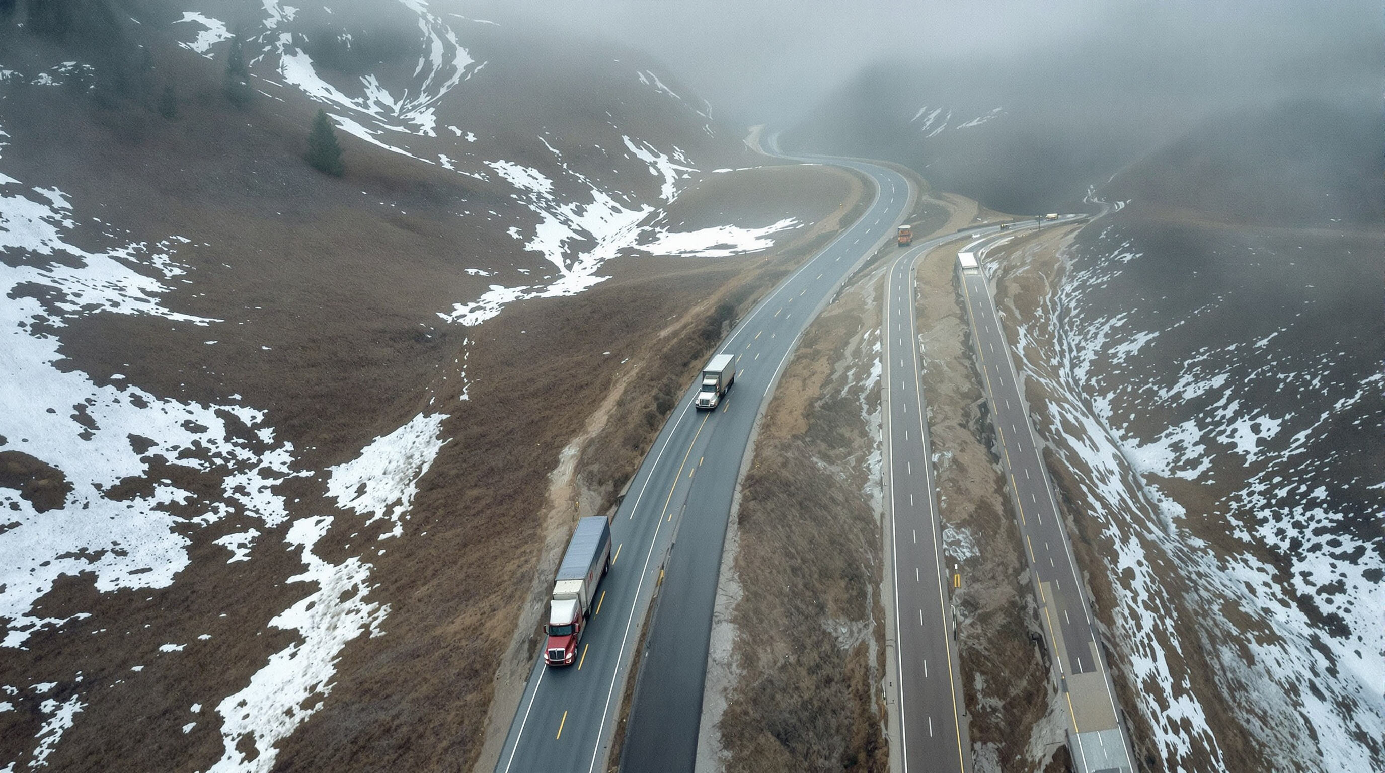 Freight trucks on different routes, one in mountains and one on a rural flat road, showing route complexity and environment.