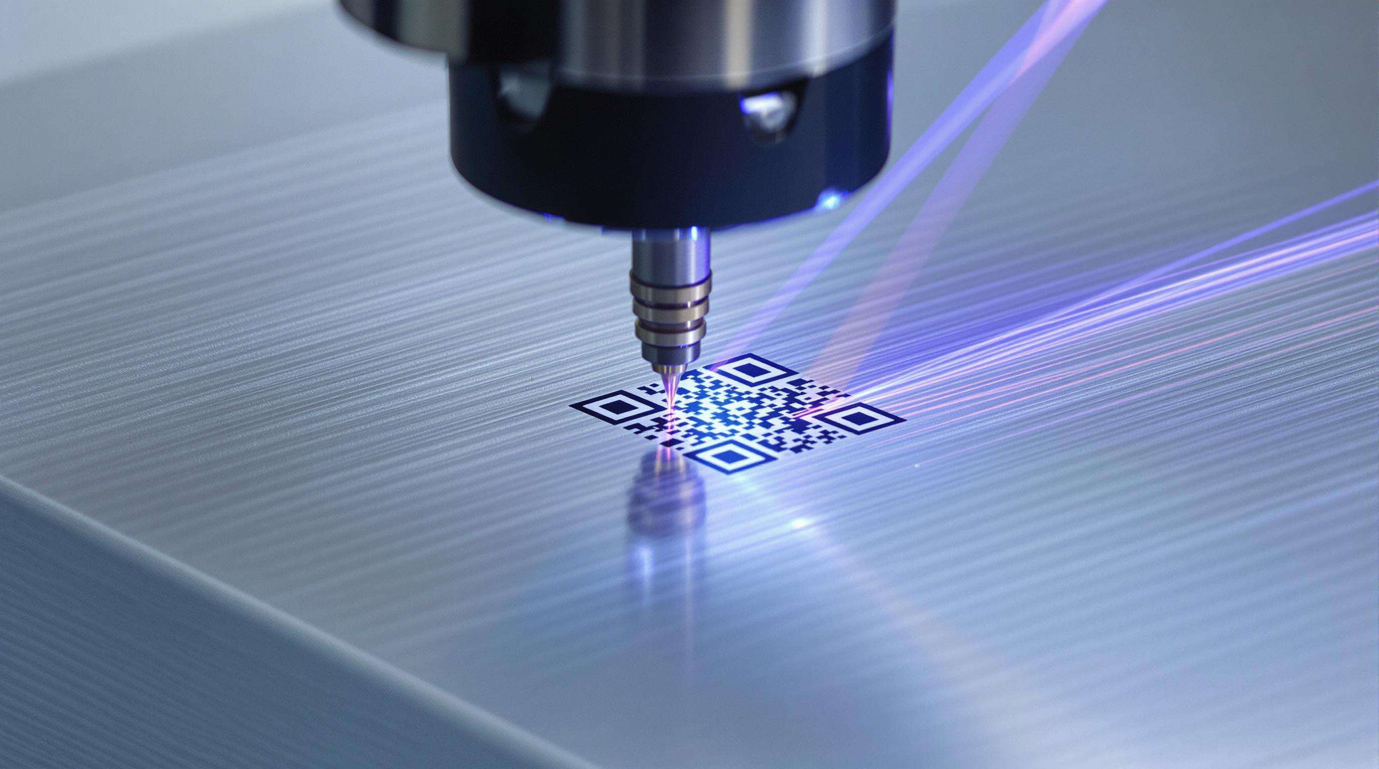 Fiber laser marking machine engraving a high-precision QR code on a small medical implant