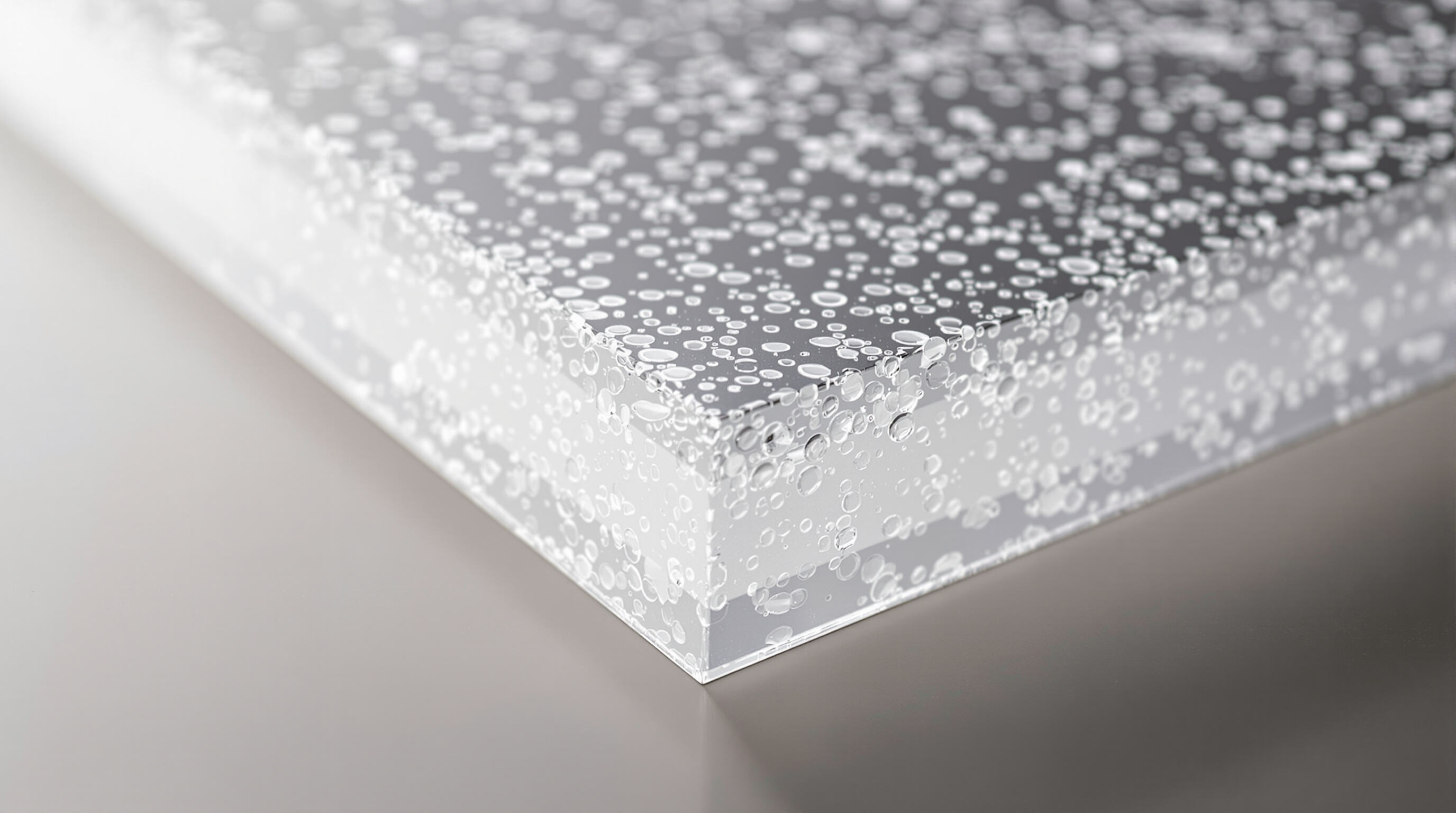 Close-up cross-section view of a clear polycarbonate sheet showing embedded nanoparticles and layered structure