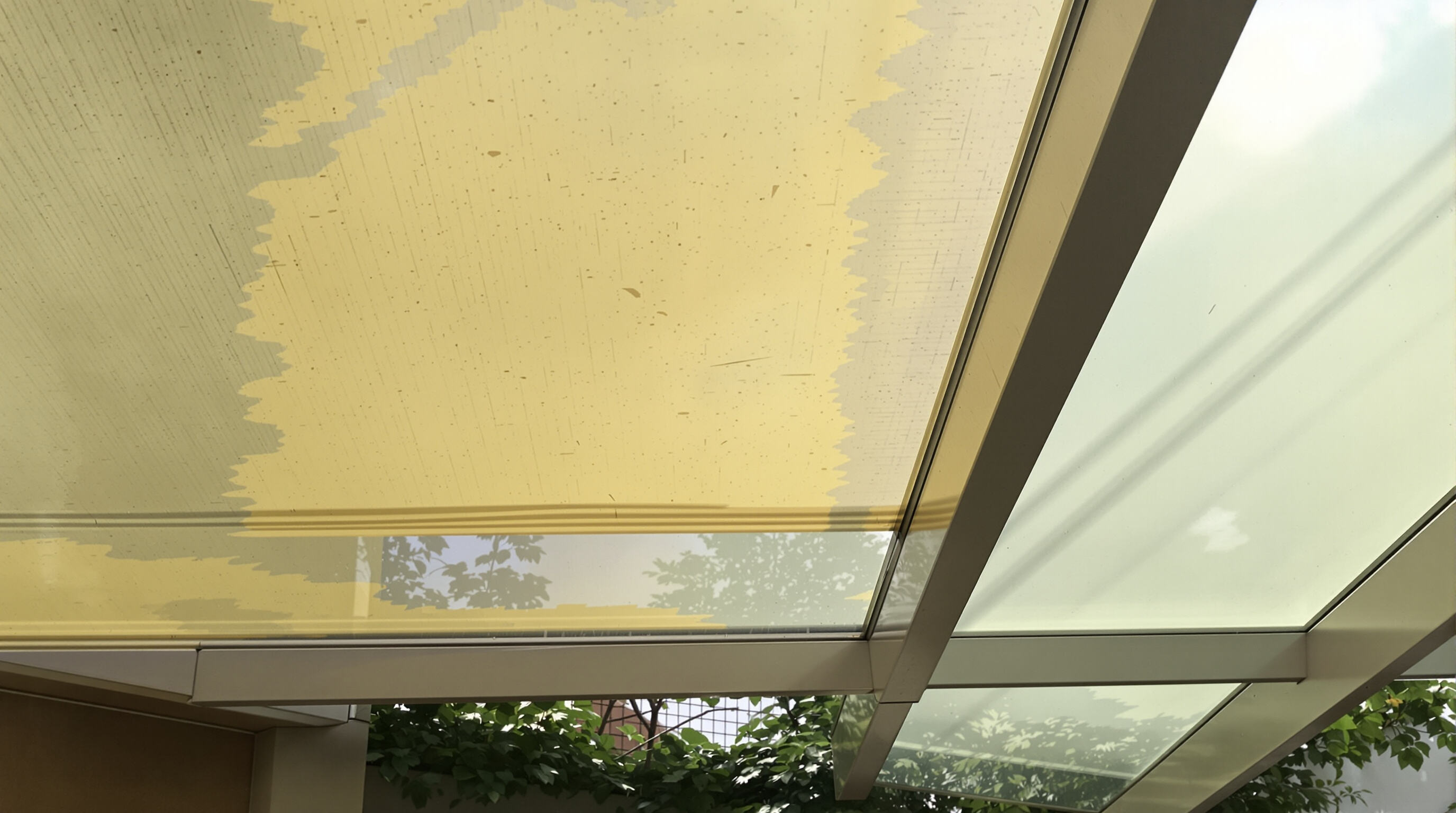 Polycarbonate canopy showing signs of yellowing and surface brittleness from sunlight exposure