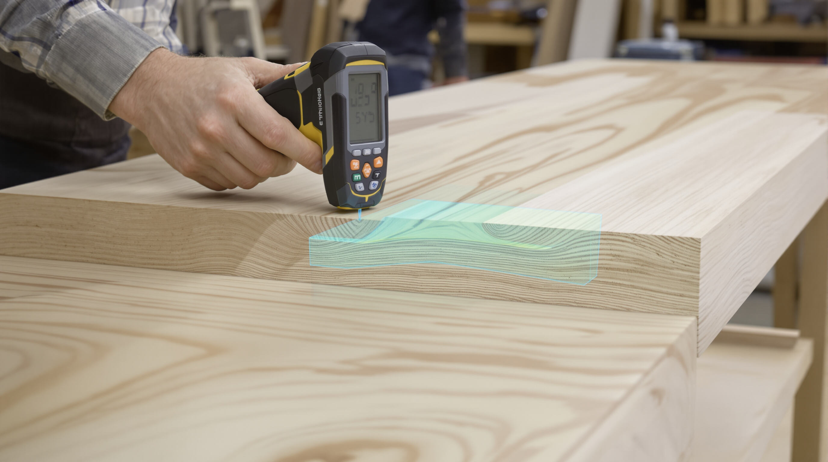 Person scanning a finished wooden table with a pinless moisture meter, showing preserved surface and wood layers