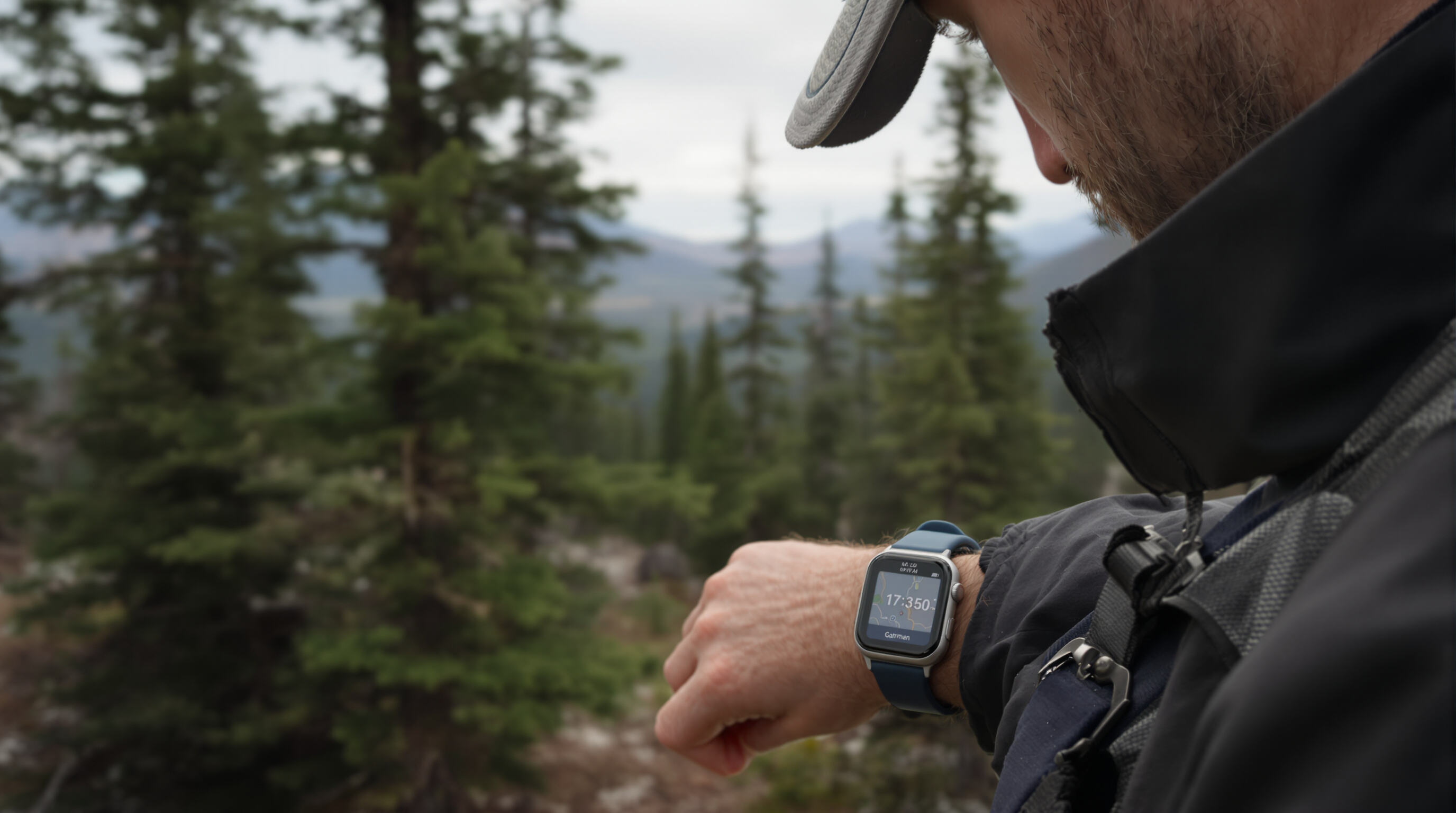Adventurer using GPS smartwatch with offline map in a remote forested mountain area