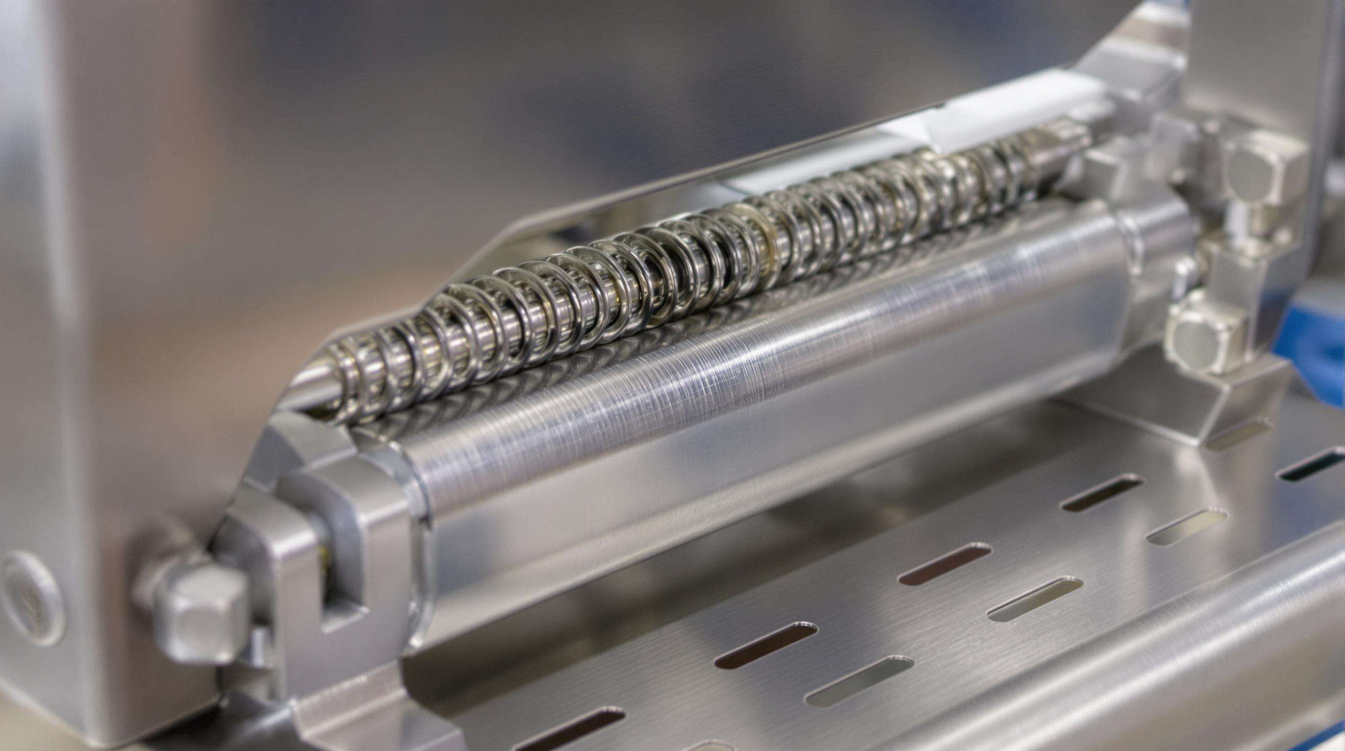 Close-up of a hygienic stainless steel garlic peeler with sealed surfaces and integrated cleaning ports