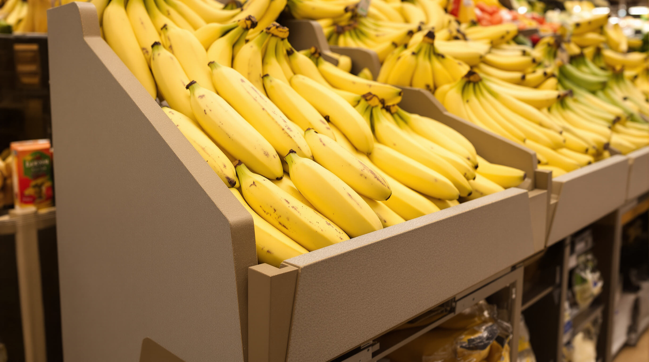 Close-up photo of a composite-material banana stand in a grocery store, showing modular construction and fresh bananas.