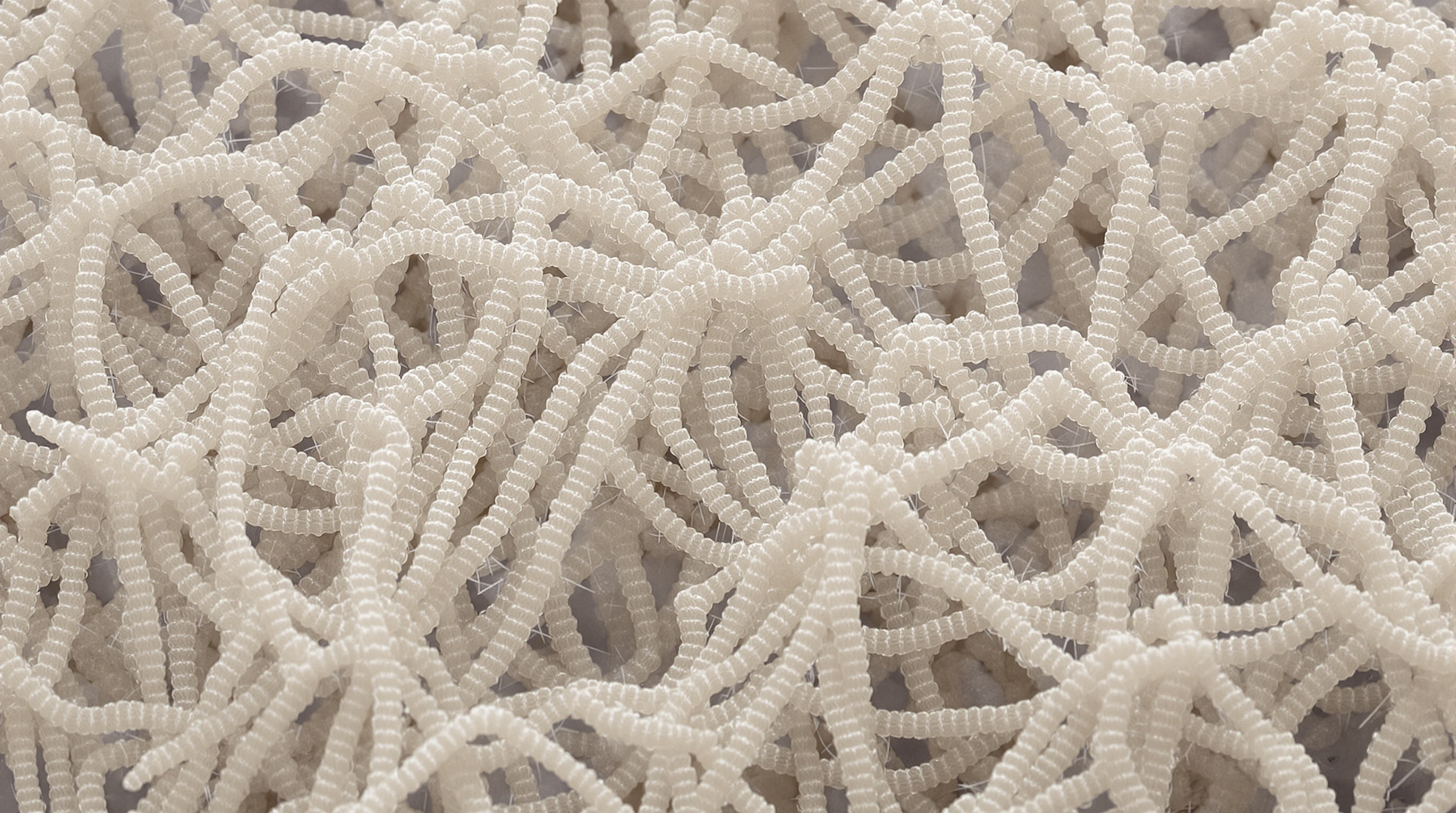 Macro photo of aramid fibers with detailed molecular patterns and rigid interwoven structure