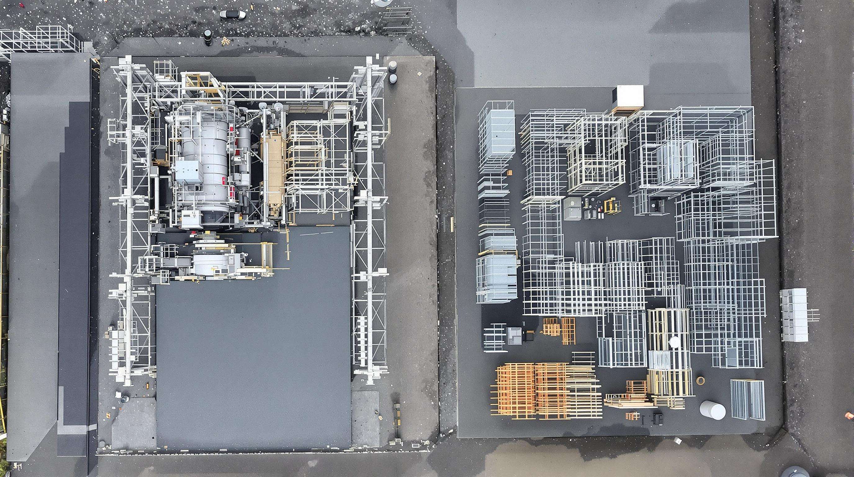 Overhead view showing slipform paver machinery setup next to traditional fixed-form equipment at a construction site