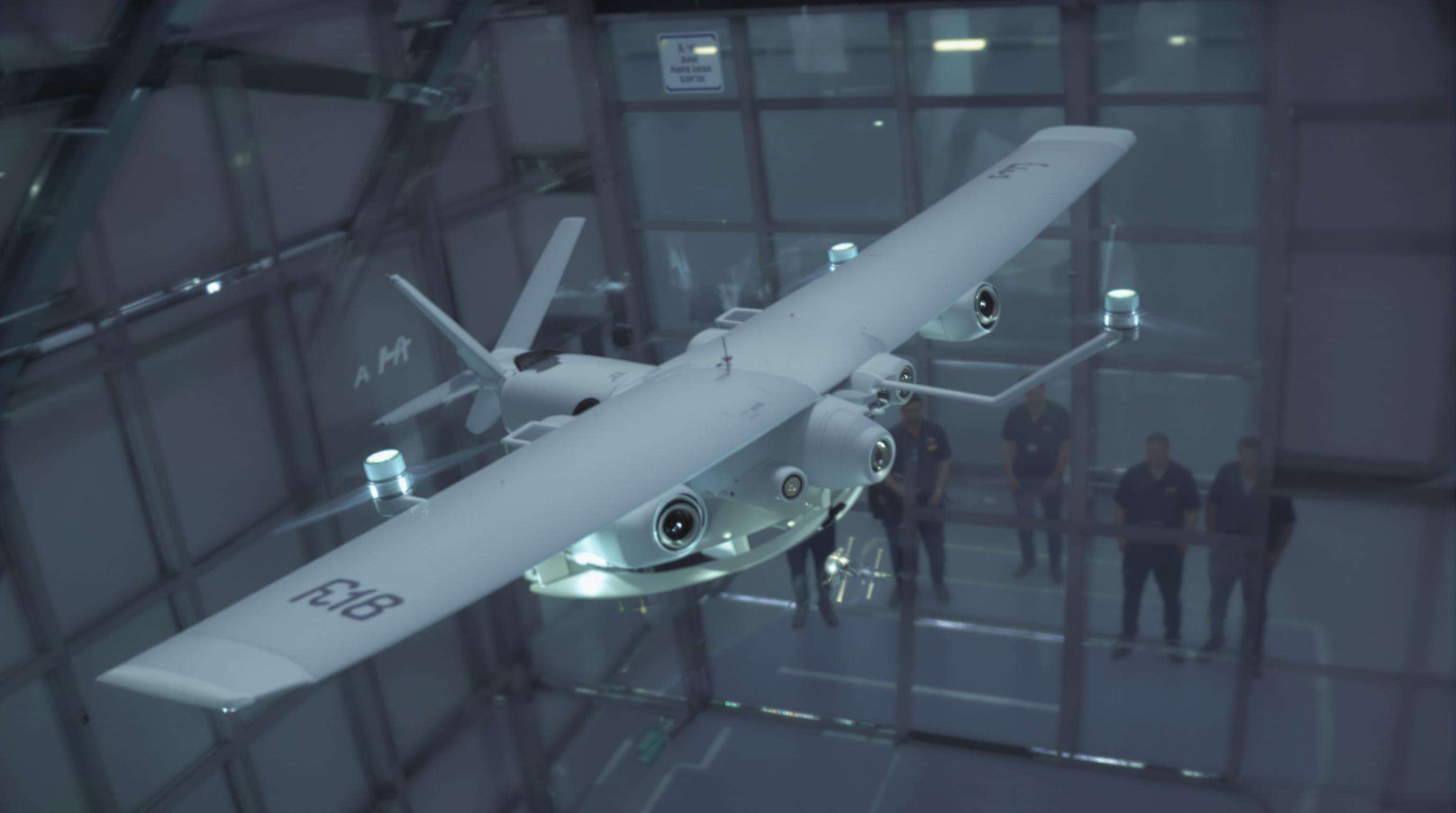 UAV with integrated speakers undergoing aerodynamic testing in a wind tunnel