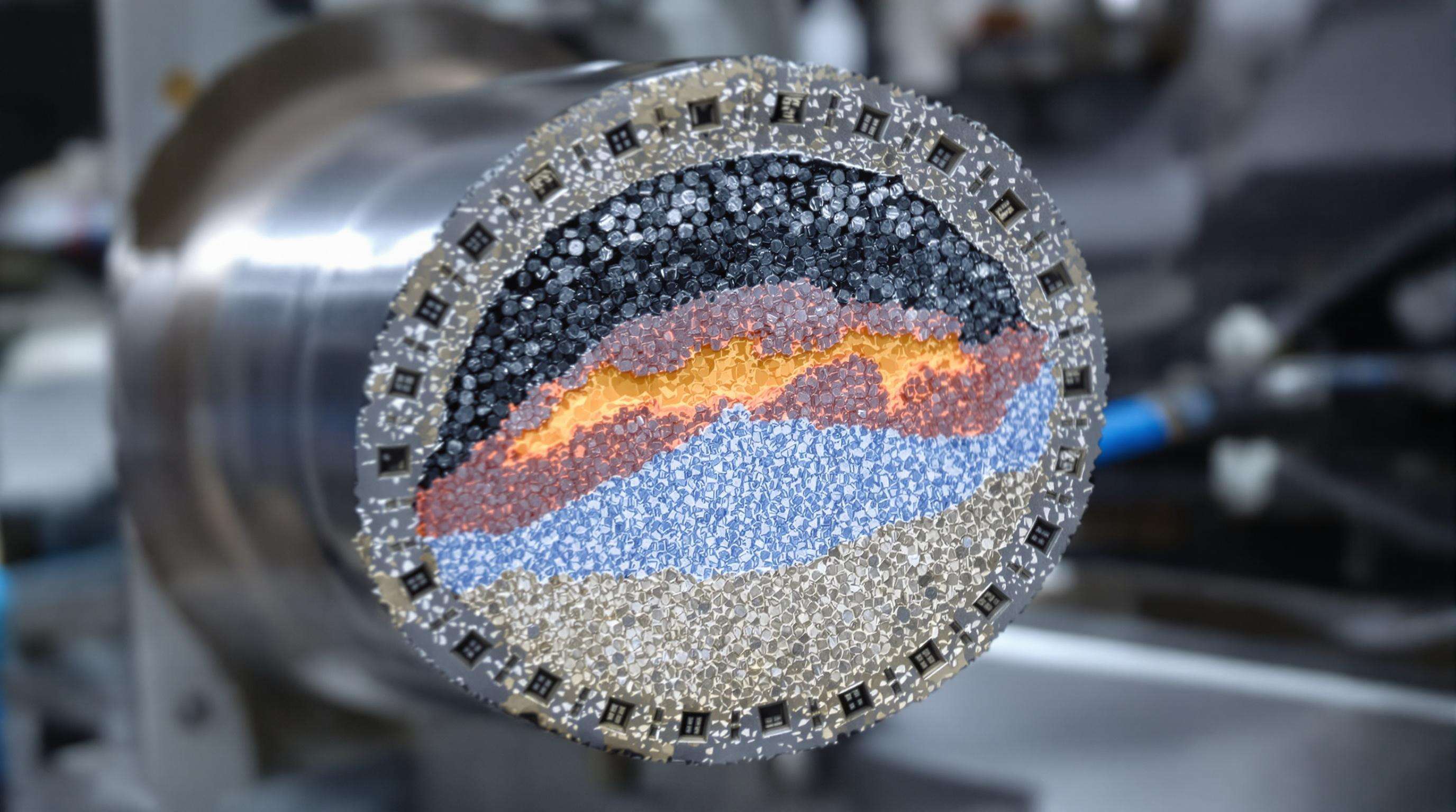 Microscopic cross-section of a hardfacing wire alloy displaying chromium carbides and carbon zones