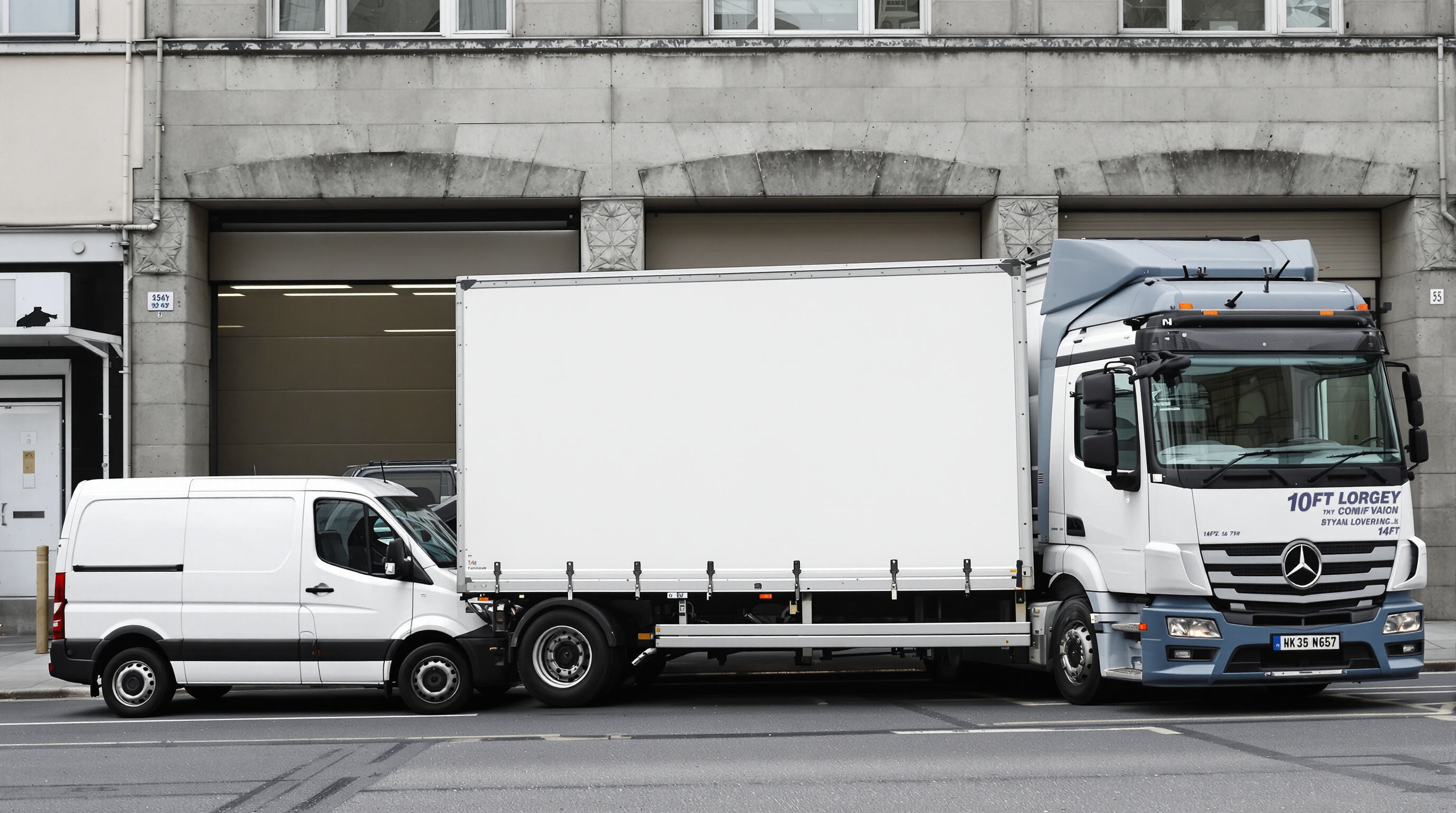 Fleet of light commercial vehicles showing a 10ft lorry between a smaller van and a larger truck in an urban loading area.