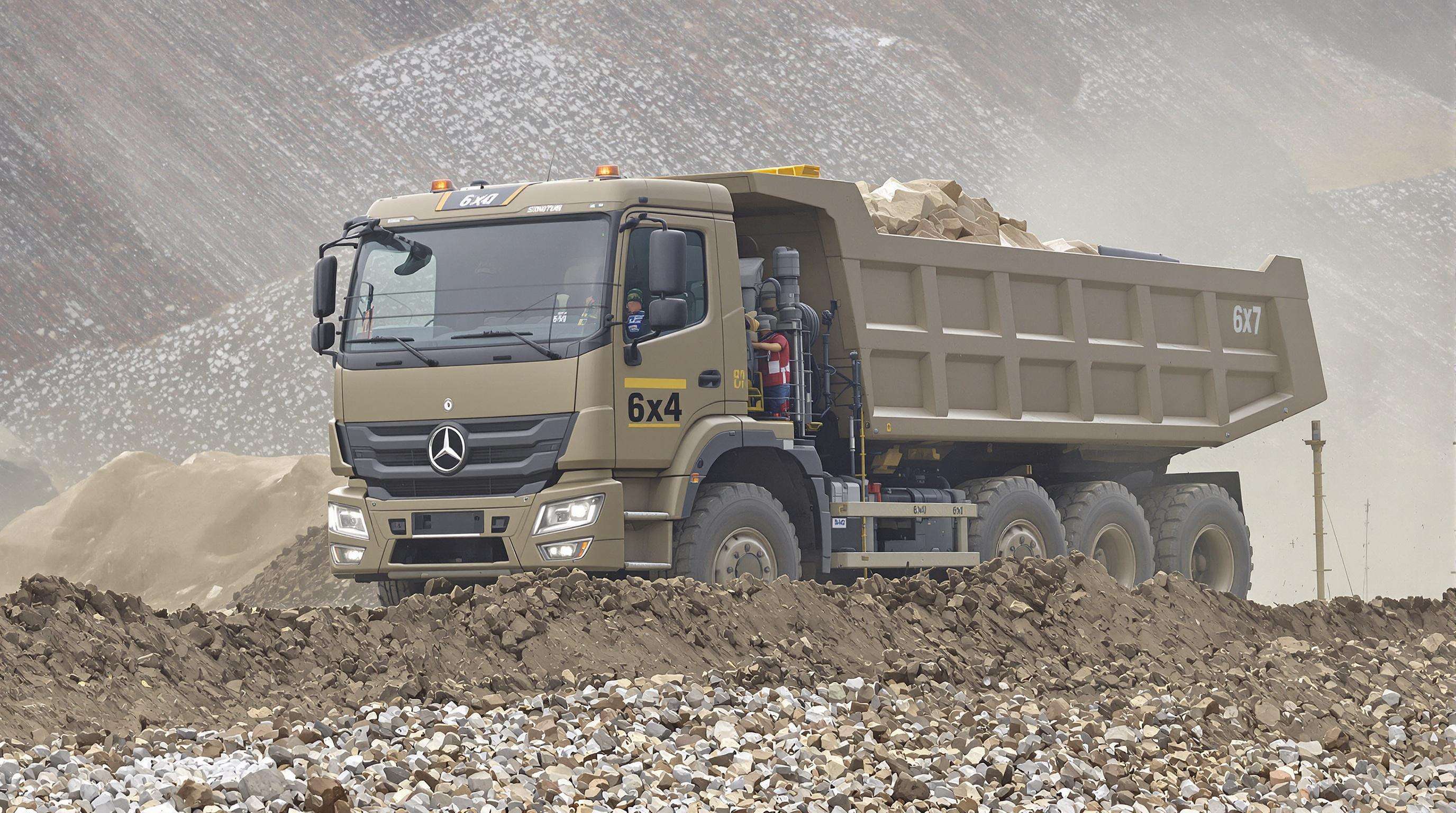 A Howo 6x4 truck hauling a full load over muddy, uneven ground at a construction site, emphasizing its dual rear powered axles.
