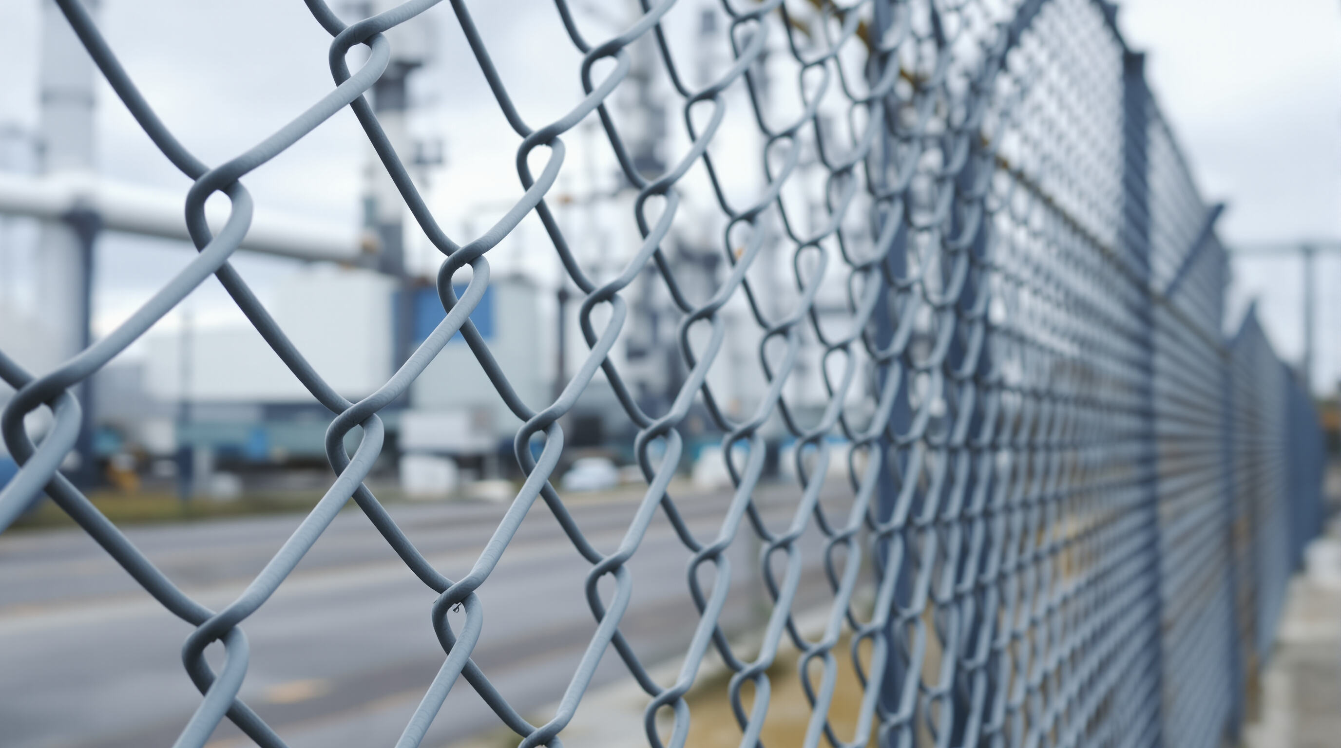 Photorealistic close-up of a 3D weld mesh fence panel showing V-shaped supports and intersecting welded steel wires.