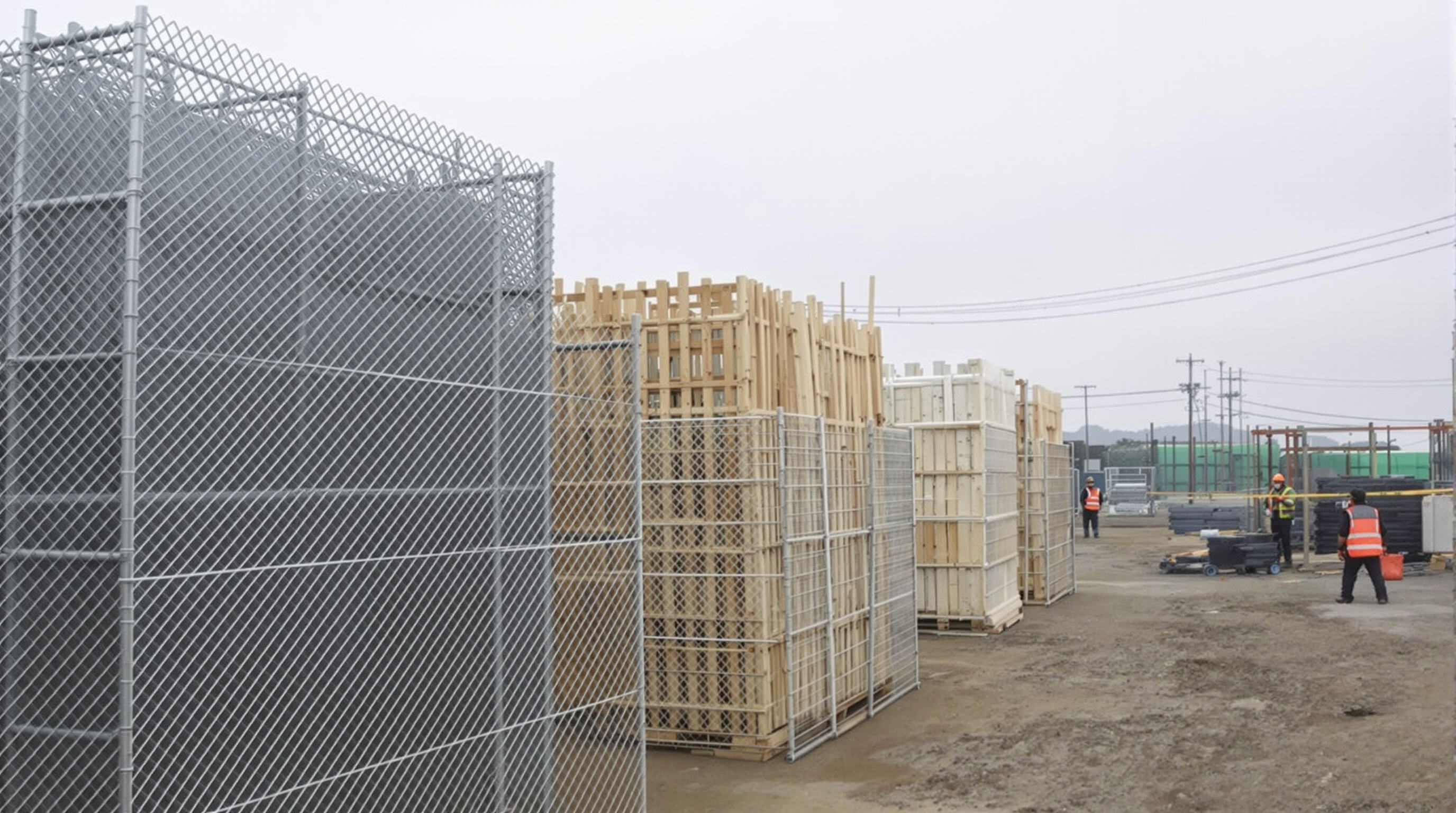 Chain link fencing and alternative barriers being compared for cost-effectiveness at a construction site