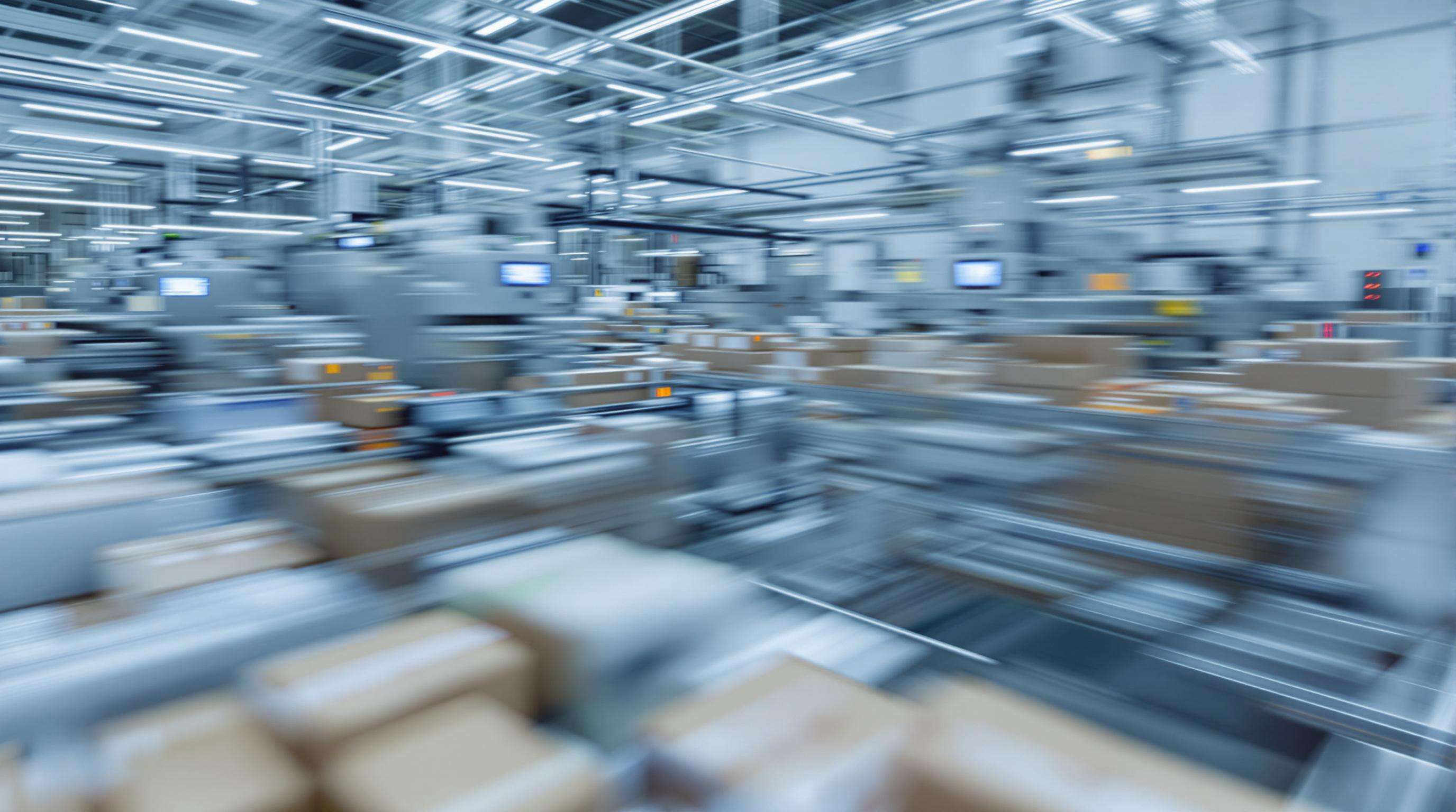 High-capacity industrial stapling machines operating on a busy factory floor