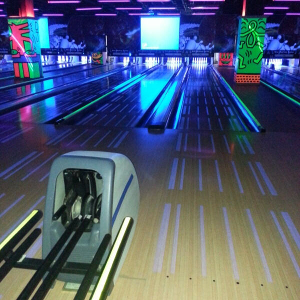 Experience the thrill of bowling in a lively arcade setting.