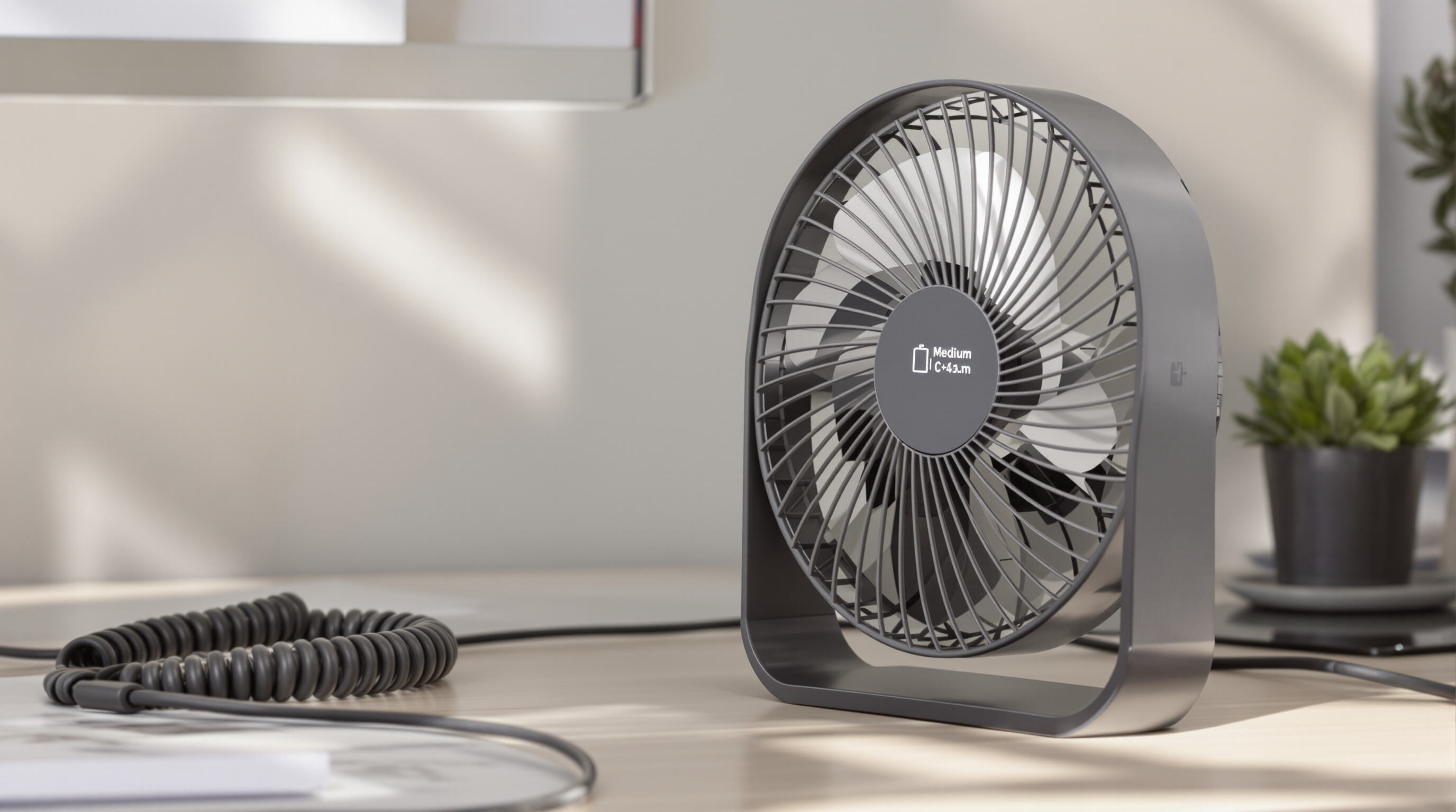 Modern rechargeable fan on desk with USB-C cable and battery indicator