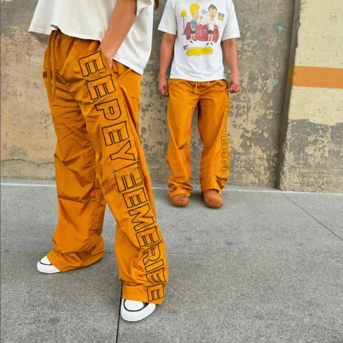 OEM Pasadyang Pagtahi ng Logo Unisex Sports Windbreak Polyester Pantaloon Waterproof 100% Nylon Track Pants para Lalaki