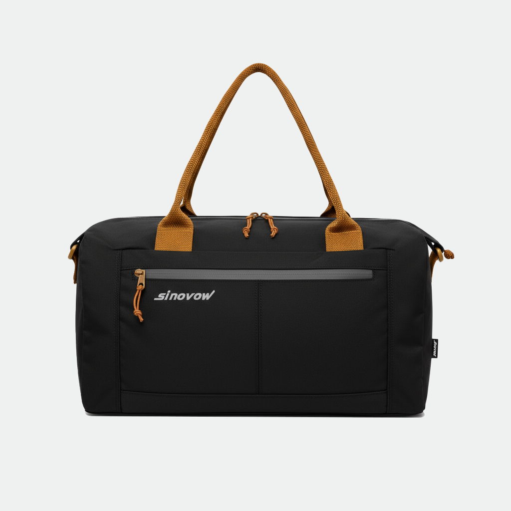 Schwarze, kompakte Reisetasche aus Ripstop-Material mit kontrastierenden orangefarbenen Griffen