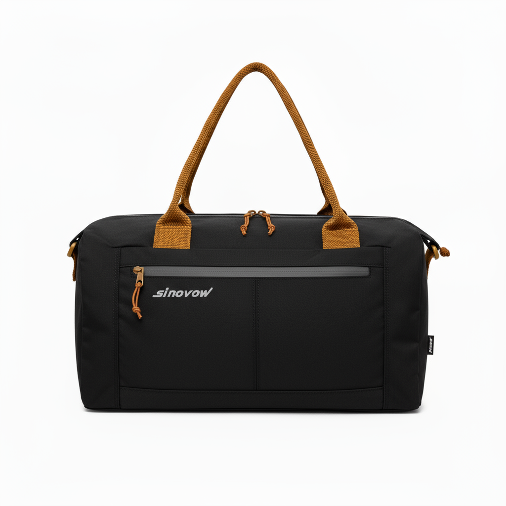 Schwarze, kompakte Reisetasche aus Ripstop-Material mit kontrastierenden orangefarbenen Griffen