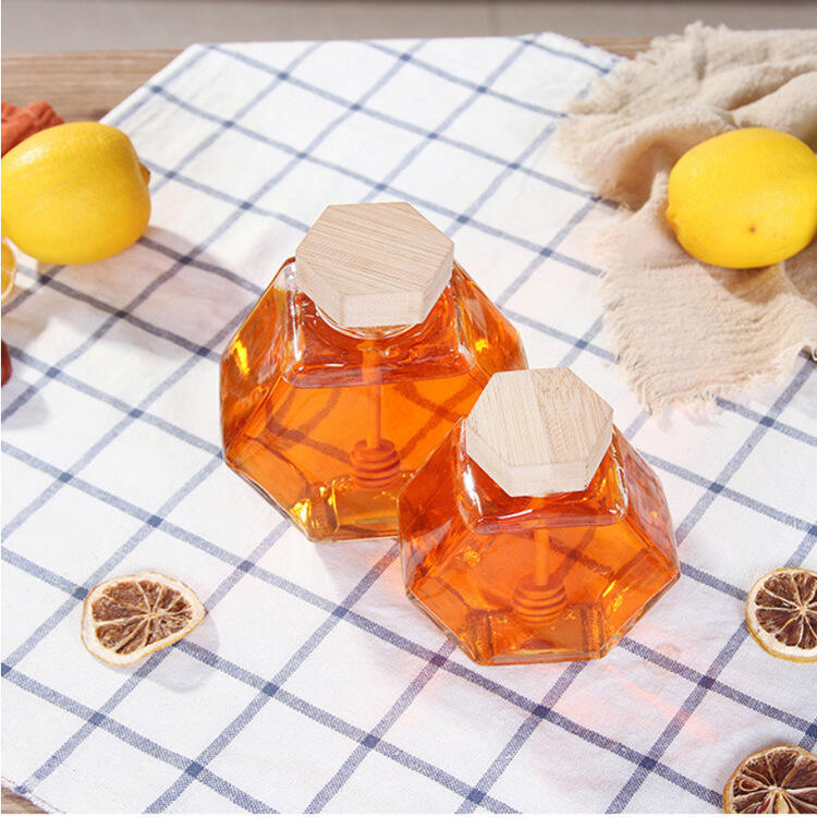 Clear empty glass honey jar with wooden lid