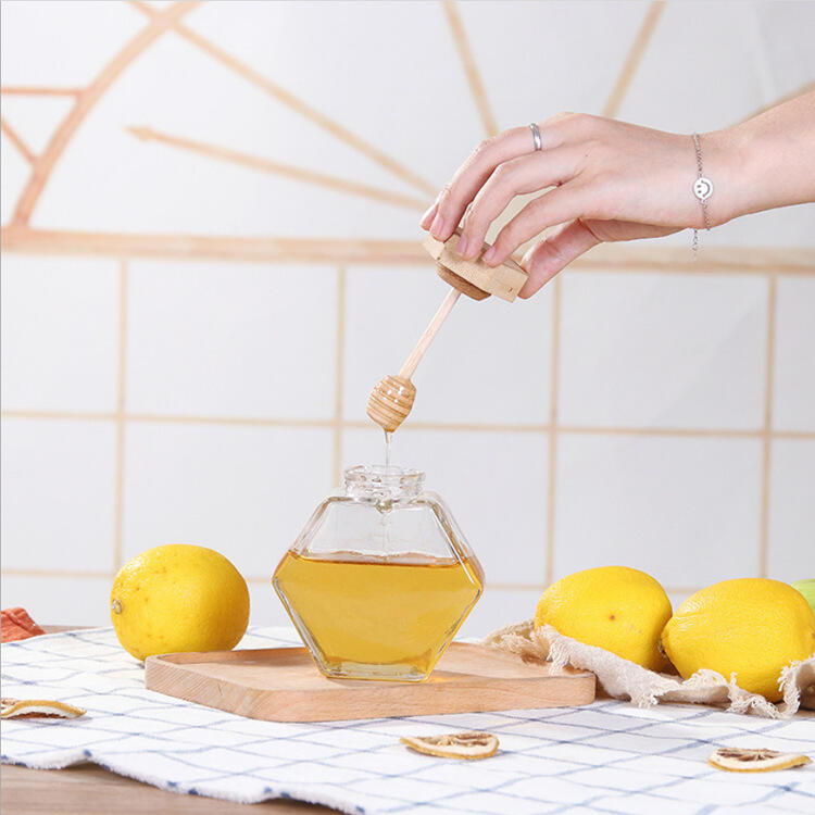 Clear empty glass honey jar with wooden lid