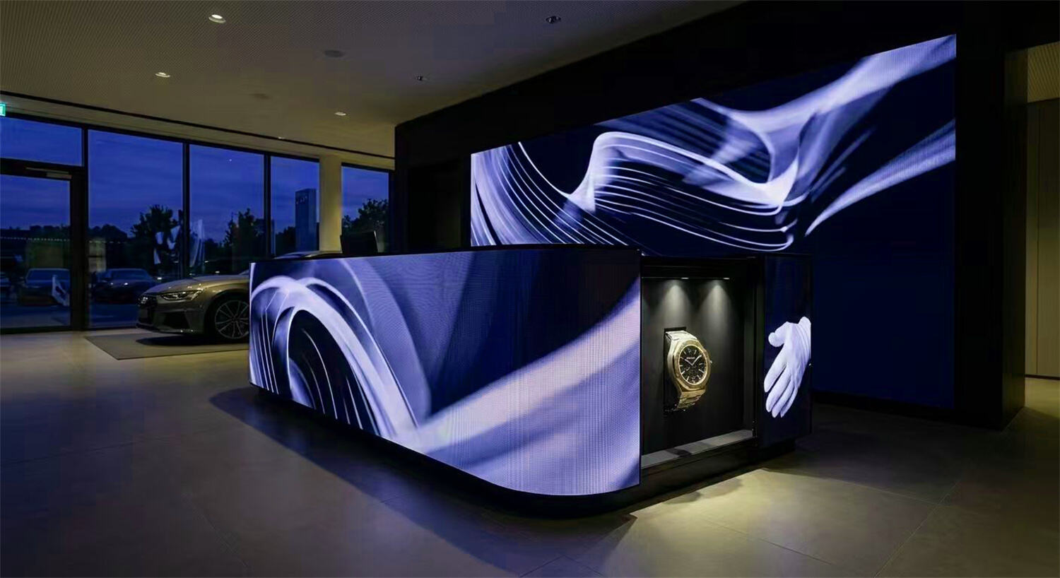 Premium reception desk with Color Art customized curved LED Fascia display integrated seamlessly into the lobby architecture.jpg