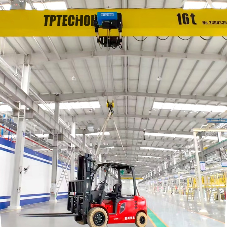 An overhead crane that moves heavy loads horizontally across the ceiling of a facility