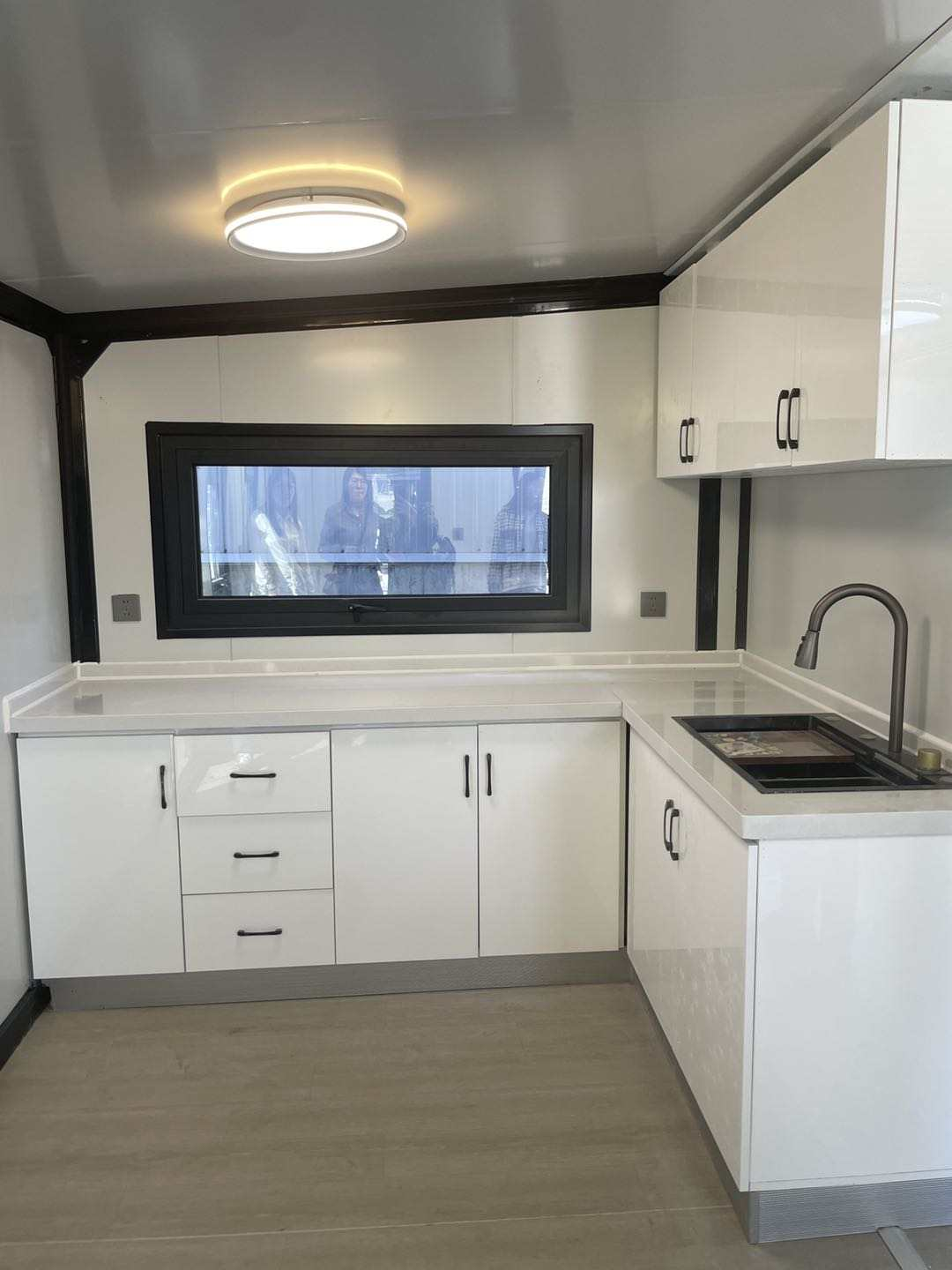 What parts of the kitchen of expandable house can be customized by the clients?