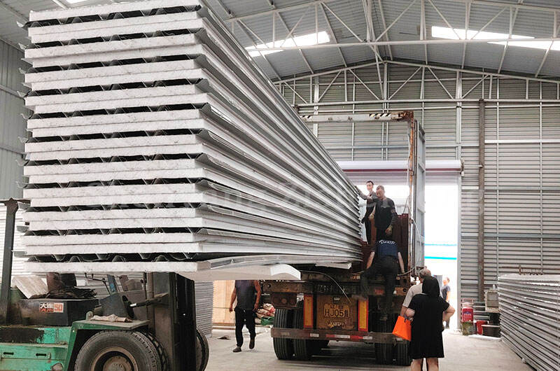 How does a sandwich panel enhance the fire resistance of steel structure buildings?
