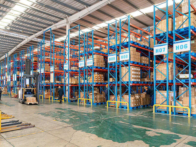 Plastic pallets are used in large warehouse shelves