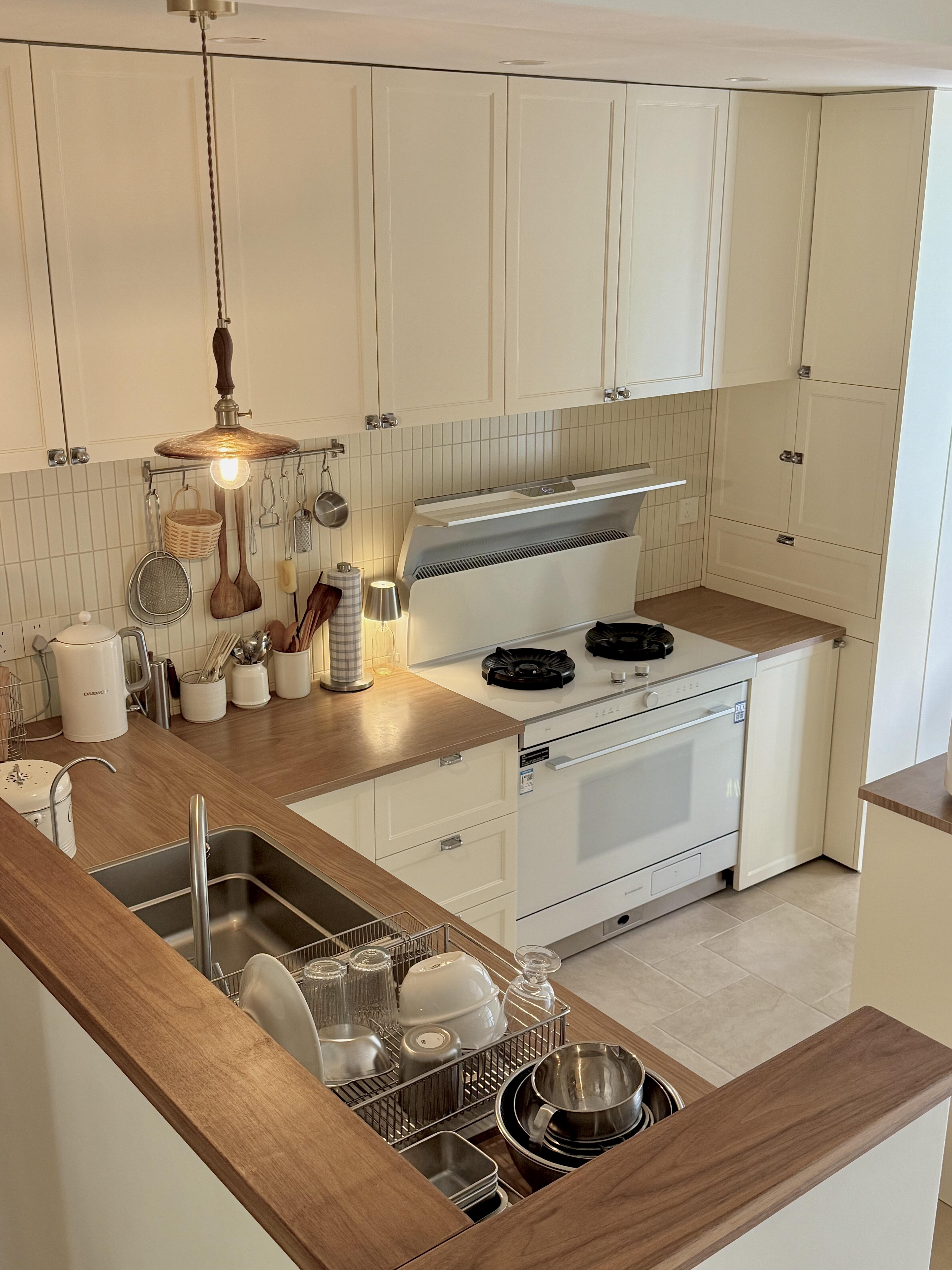 Classic Kitchen Cabinets with Cream - Colored Finish, Wooden Countertops, and Multi - functional Drawers for an Organized Home Kitchen