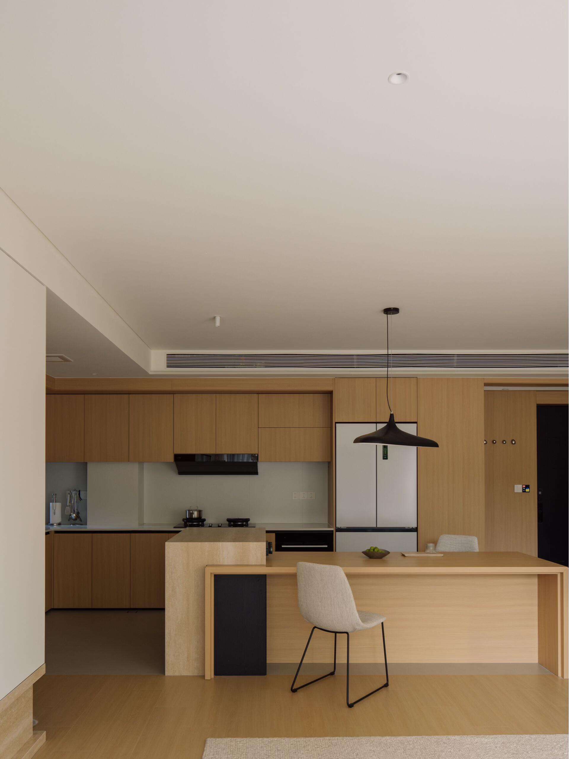 Modern Home Interior with Light Wood Tones, Neutral Color Palette, and Minimalist Shapes for Cozy Living and Kitchen Spaces