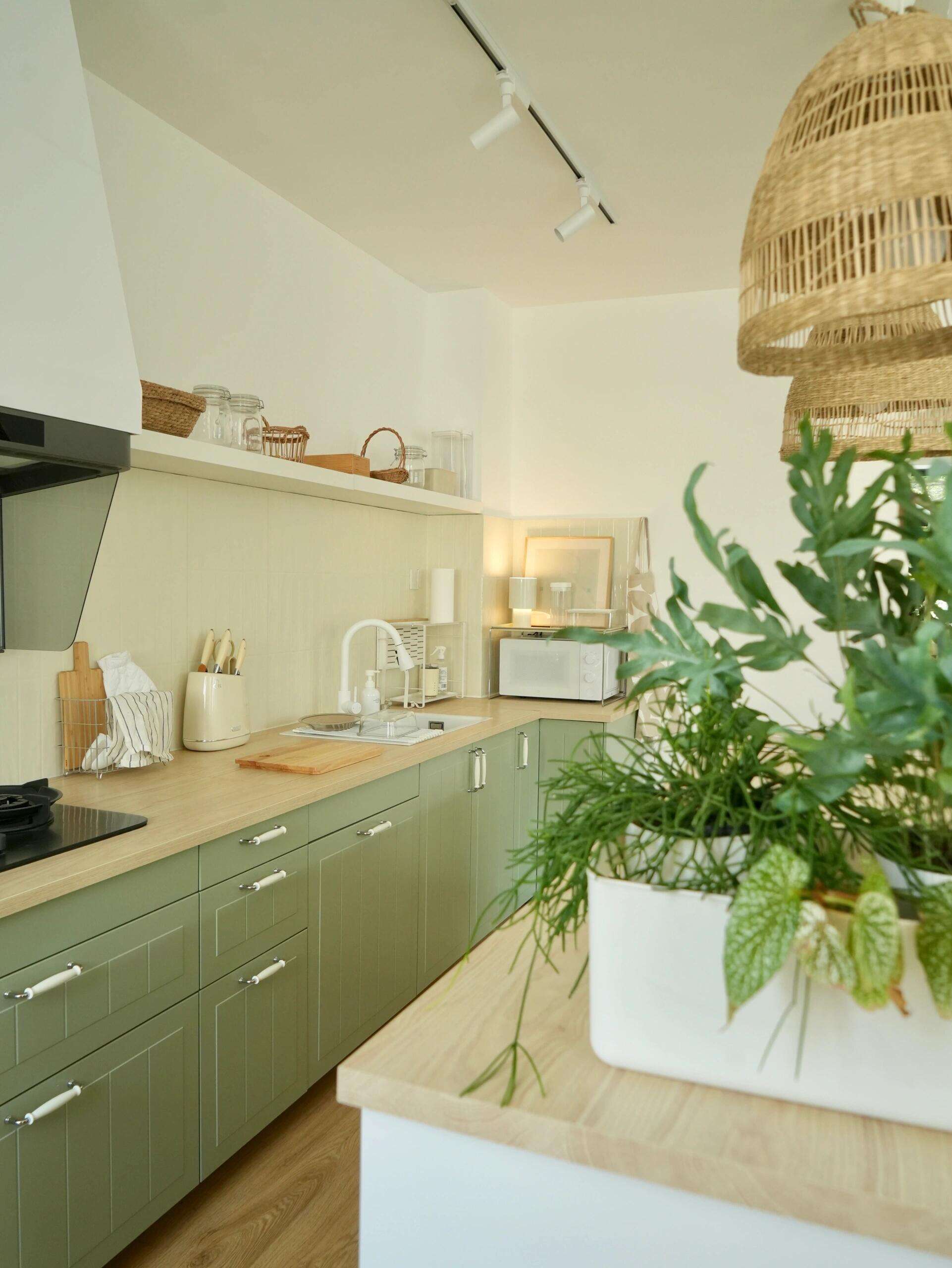 Scandinavian - Style Kitchen with Sage Green Cabinets, Light Wood Accents, and Rattan Lighting for a Cozy Home Cooking Space